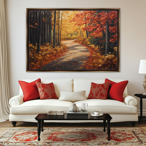 a large painting of a forest path with autumn foliage hanging on a wall above a white sofa with red throw pillows.