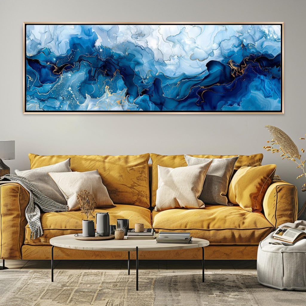 a living room with a yellow couch and a painting on the wall