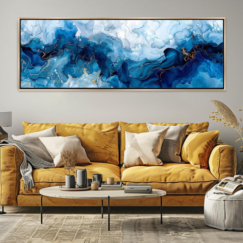a living room with a yellow couch and a painting on the wall