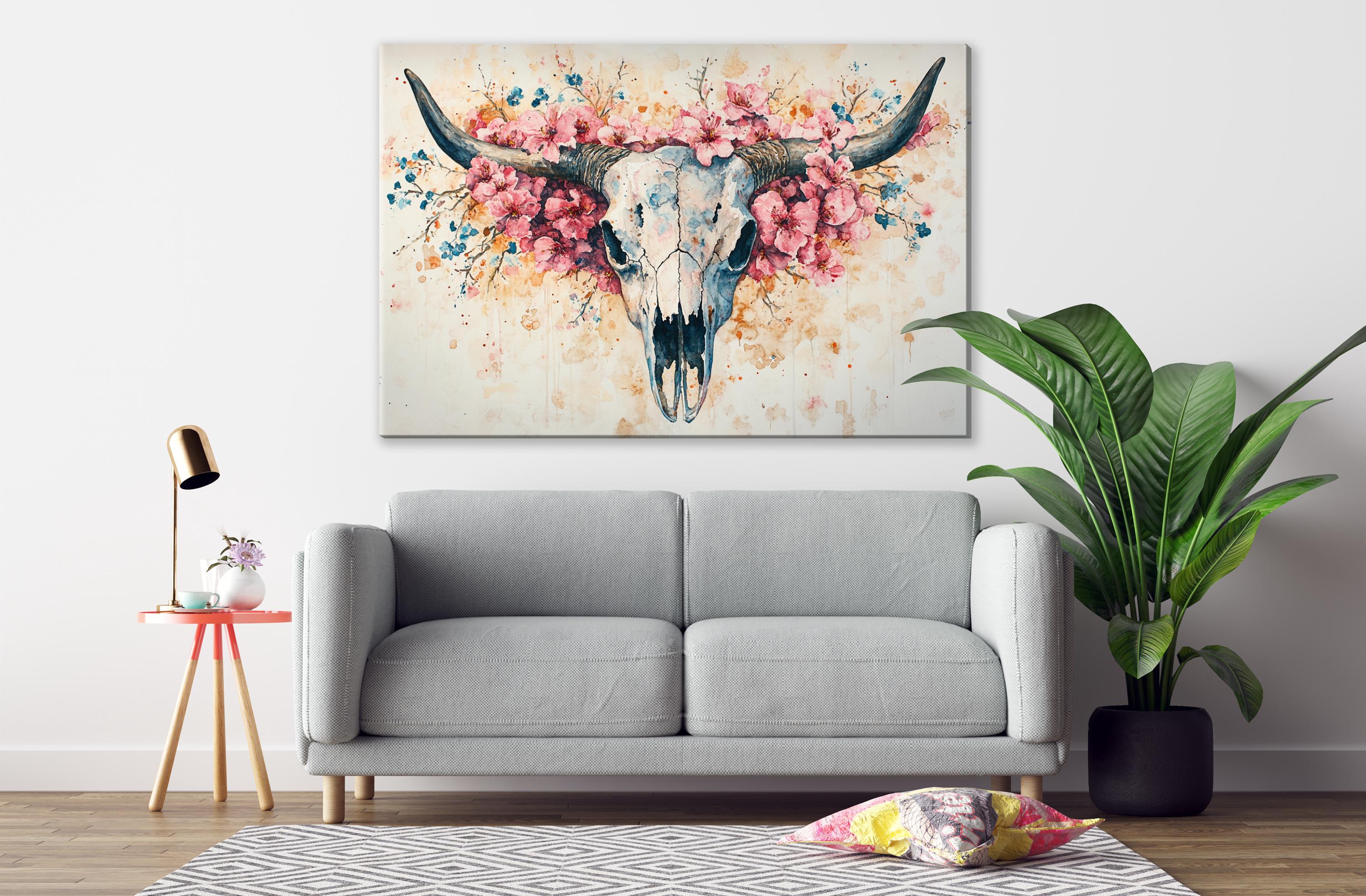 a gray sofa, a pink table lamp, a large potted plant, and a framed artwork of a skull with flowers on the wall.