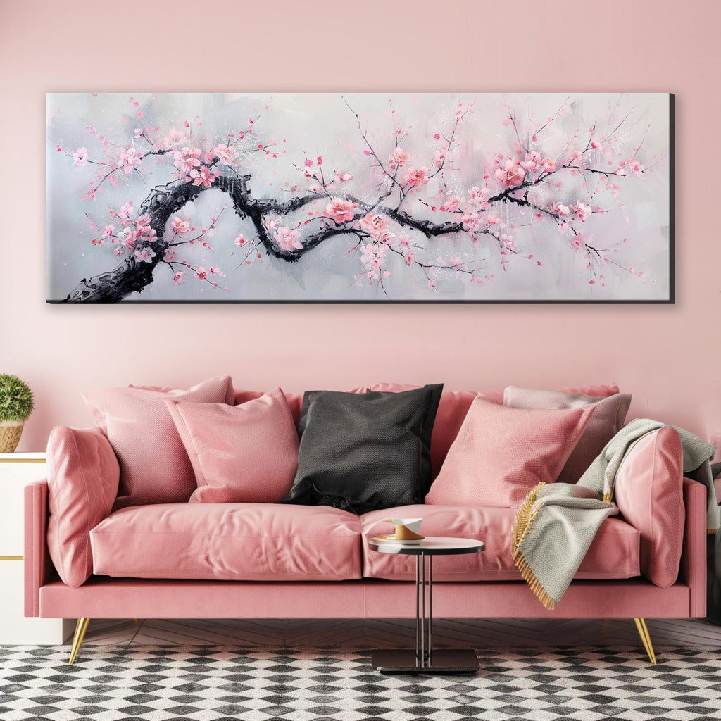a living room with a pink couch and a painting on the wall
