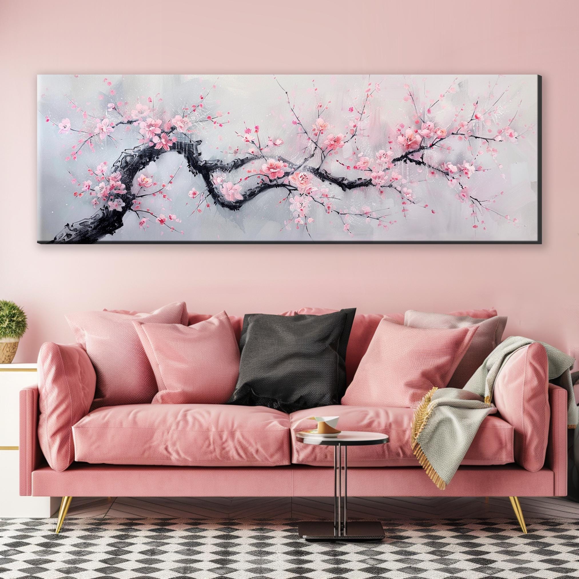a living room with a pink couch and a painting on the wall