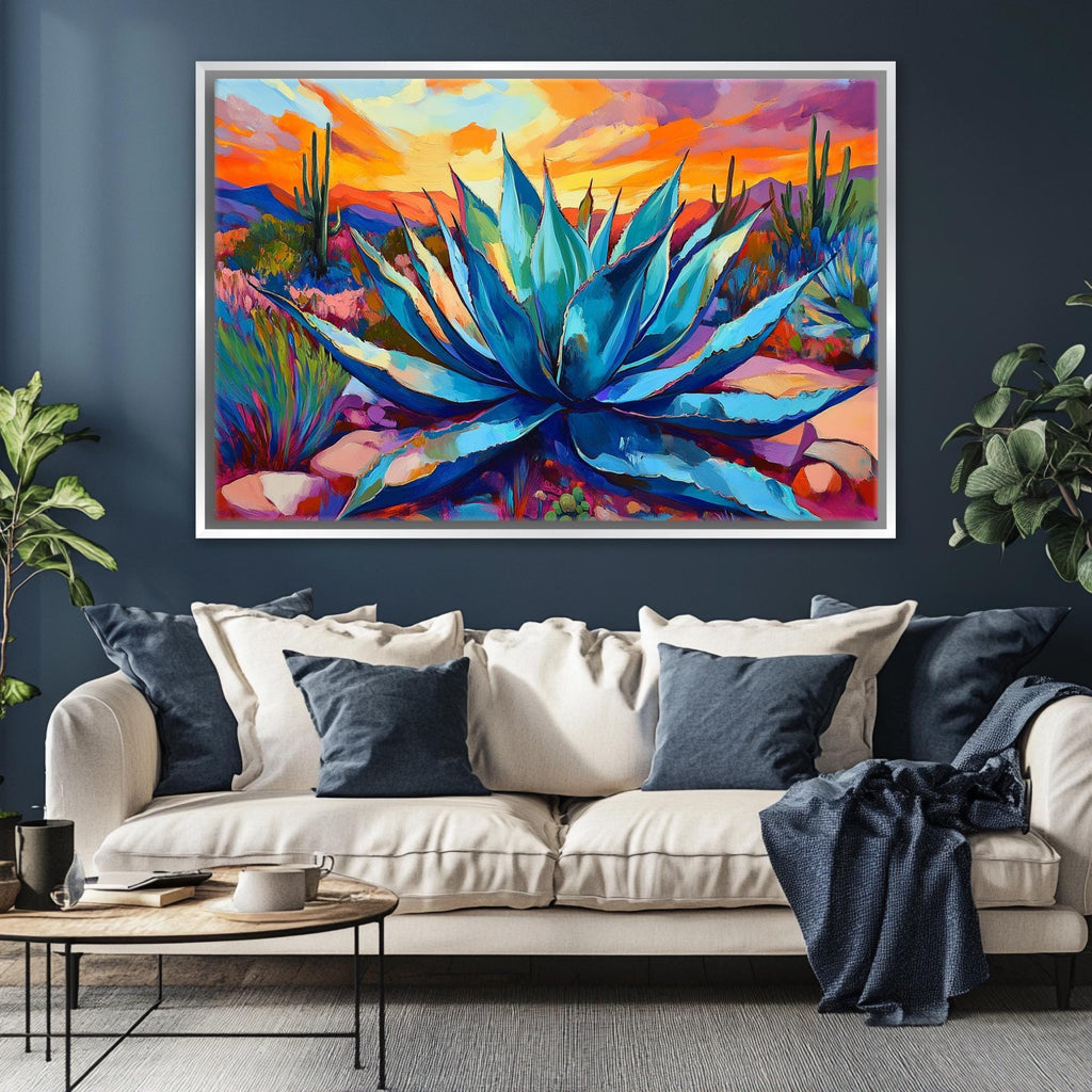 a large, colorful painting of a desert landscape with a prominent blue agave plant in the center. The painting is displayed on a wall above a white sofa with blue throw pillows.