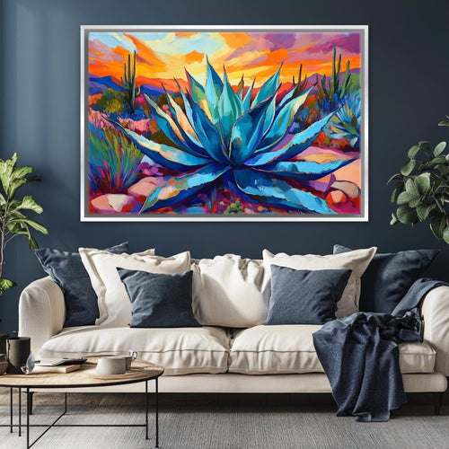 a large, colorful painting of a desert landscape with a prominent blue agave plant in the center. The painting is displayed on a wall above a white sofa with blue throw pillows.
