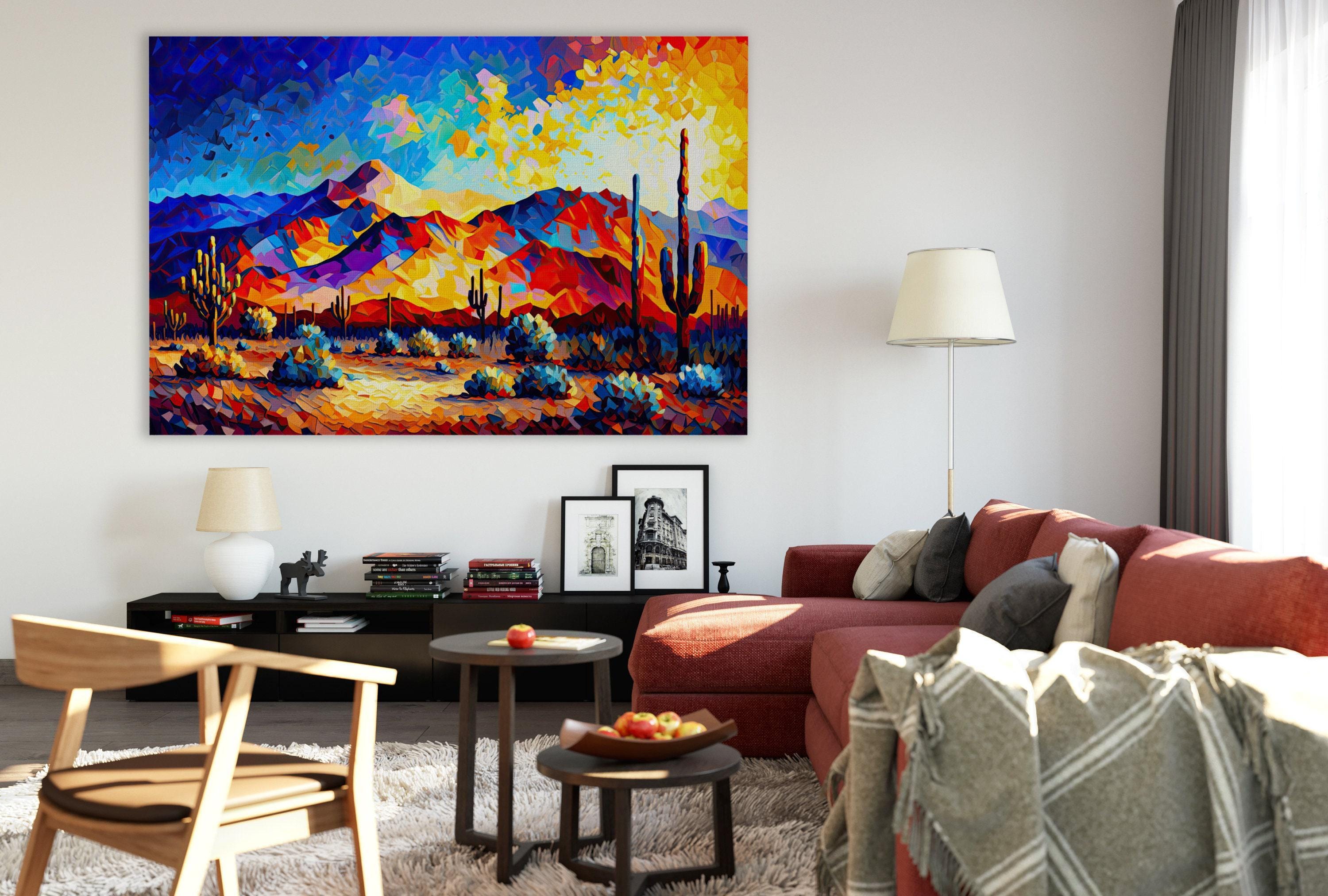 a modern living room with a large, colorful painting of a desert landscape hanging on the wall. The room is furnished with a red sofa, a wooden chair, and a coffee table with a bowl of fruit. The overall decor has a contemporary and vibrant feel, with the painting serving as a focal point in the space.