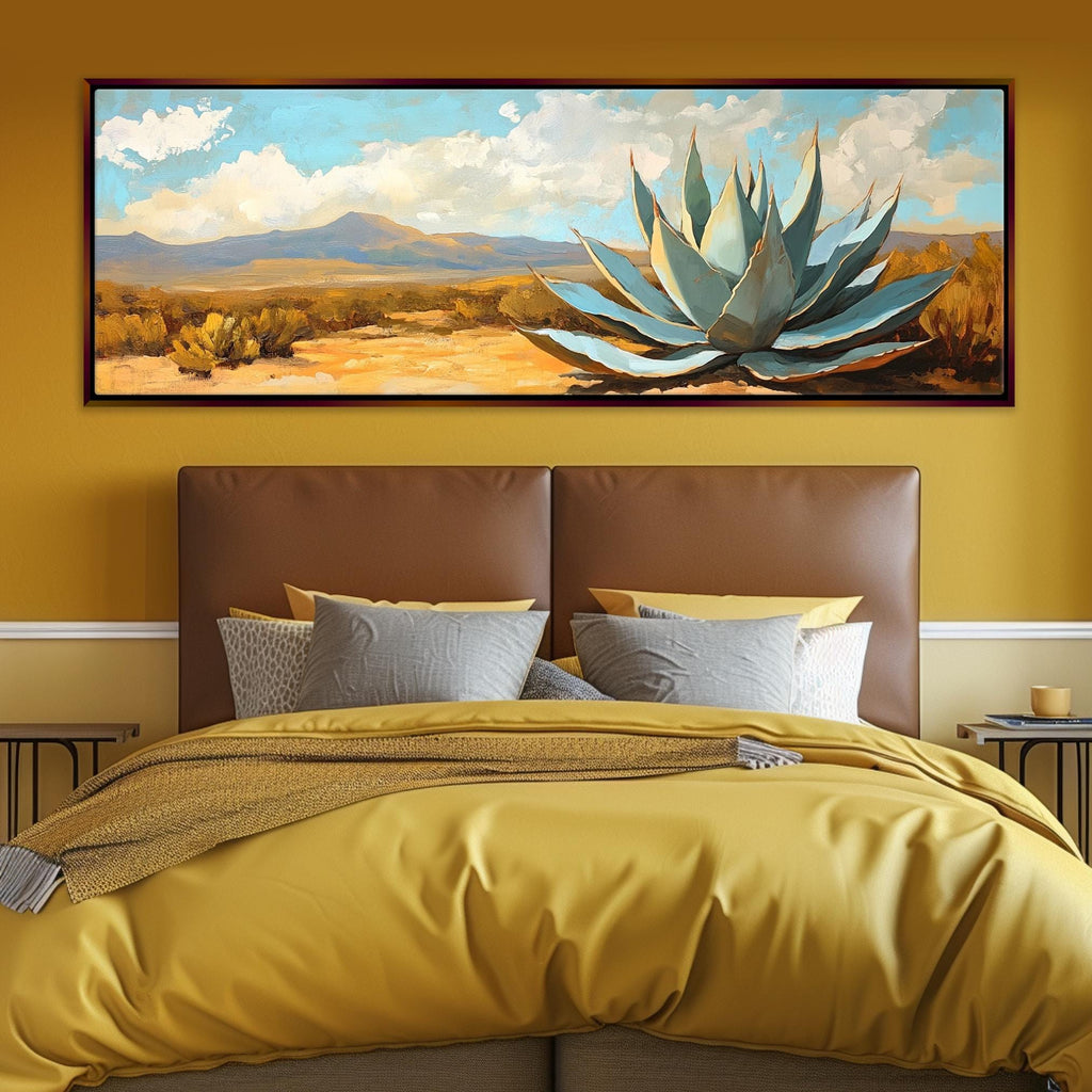 a bed with a yellow comforter and a painting on the wall