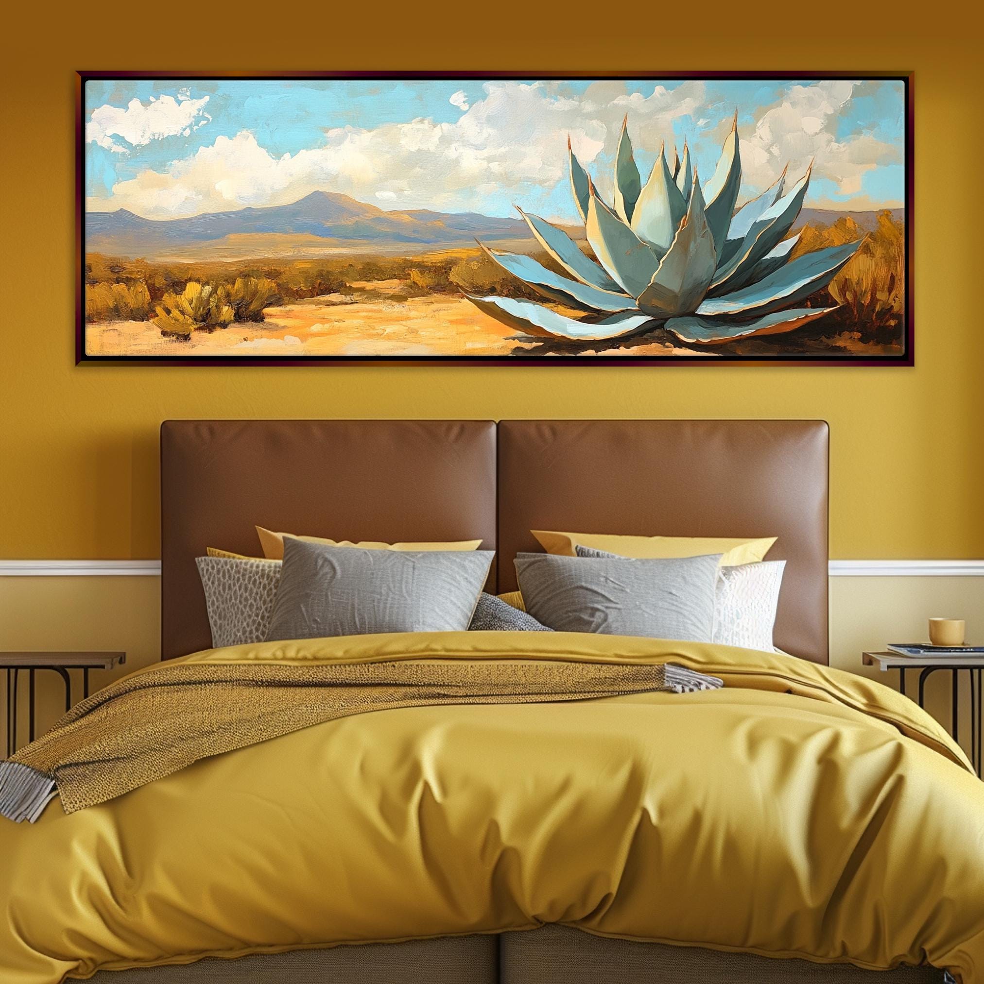 a bed with a yellow comforter and a painting on the wall