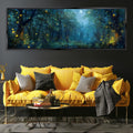a cozy living room with a large, vibrant yellow sofa adorned with throw pillows and a black and white patterned blanket. Above the sofa, a large, framed painting depicts a serene forest scene with a full moon and twinkling fireflies. The room also includes a coffee table with a stack of books and a vase of flowers, creating a warm and inviting atmosphere.