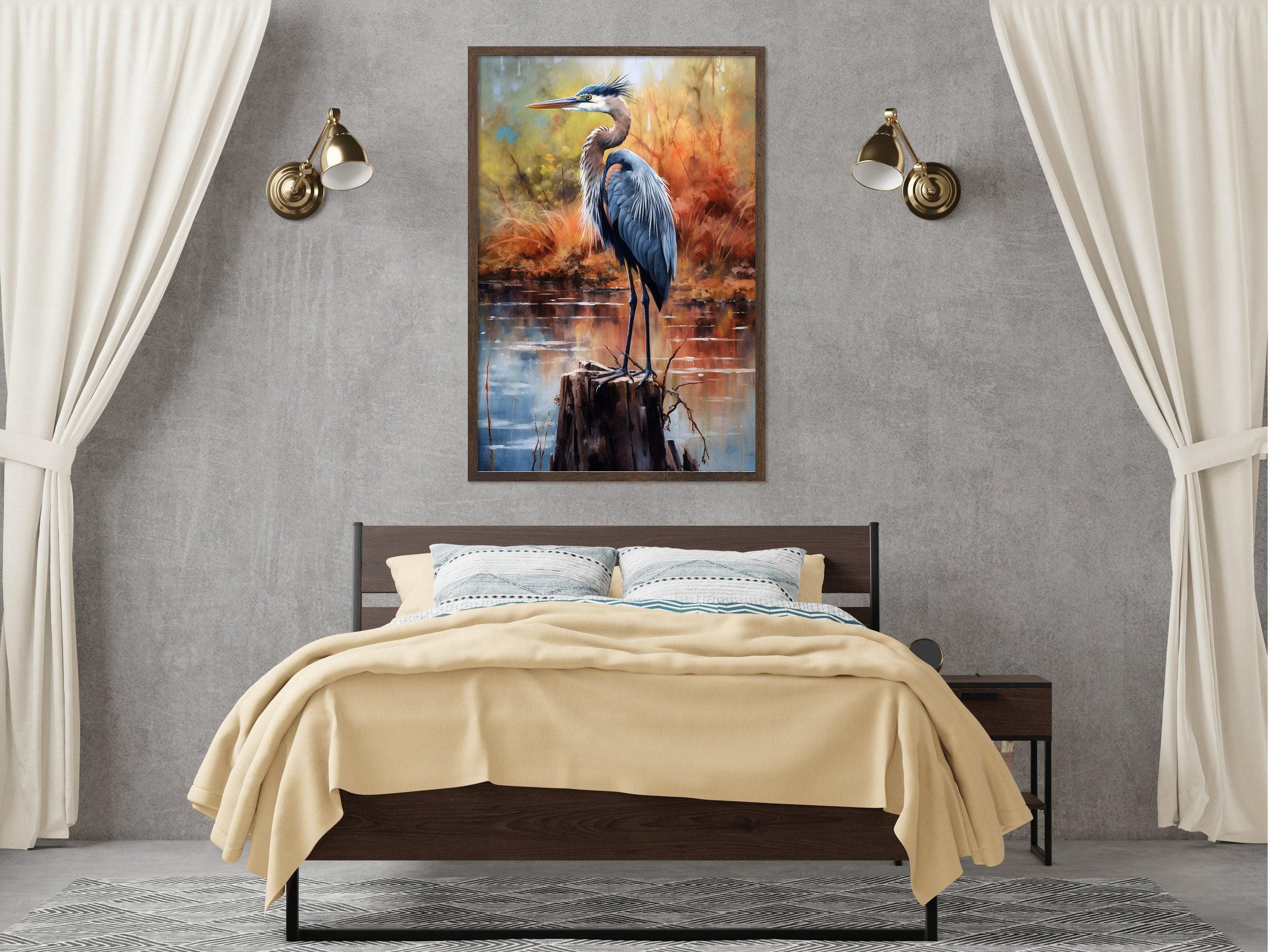 a bedroom with a large bed, a nightstand, and a framed painting of a blue heron standing on a log. The painting is hung on the wall above the bed, creating a serene and natural atmosphere in the room.
