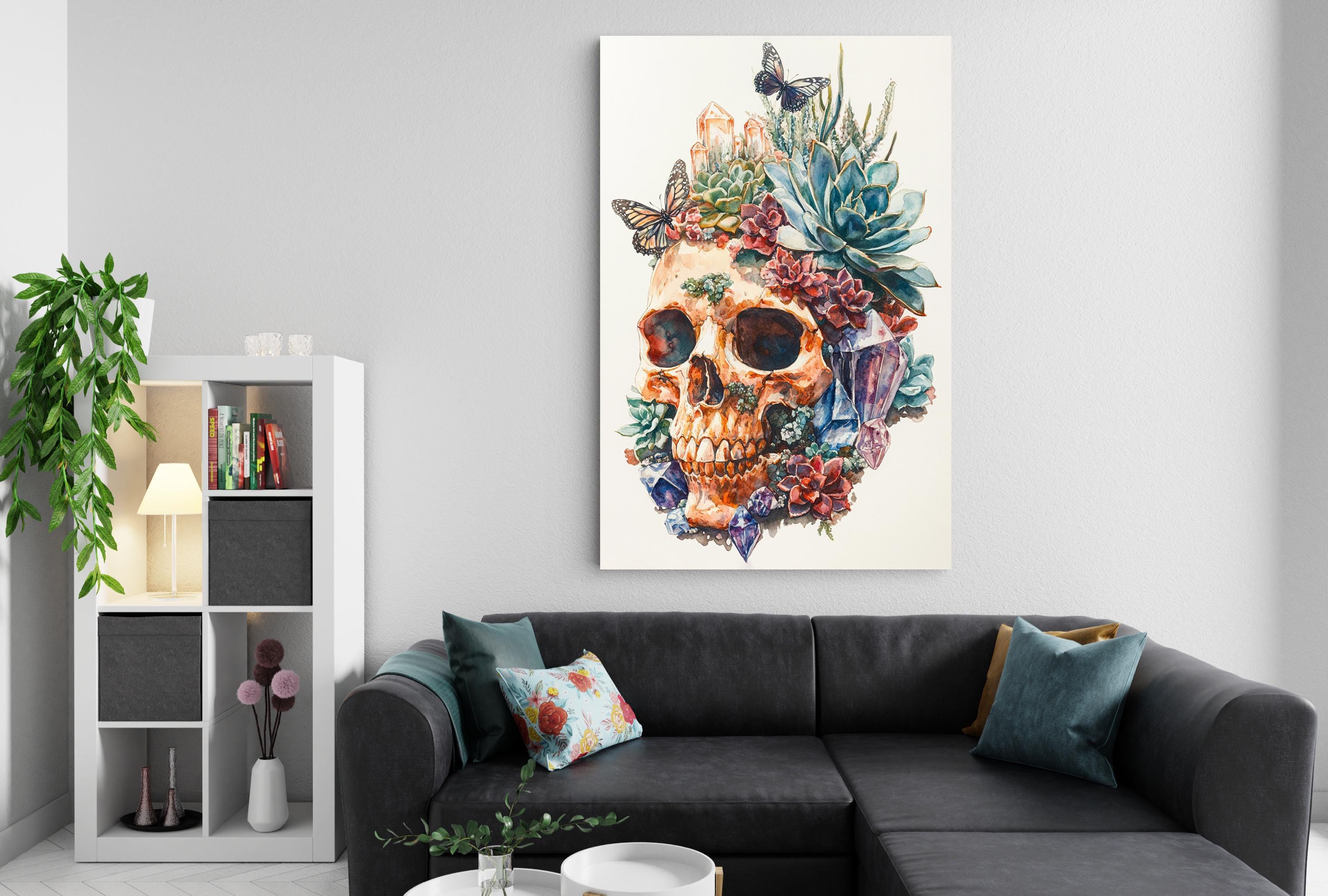 a large, colorful painting of a skull adorned with flowers and butterflies, hanging on a wall above a black couch in a living room setting.