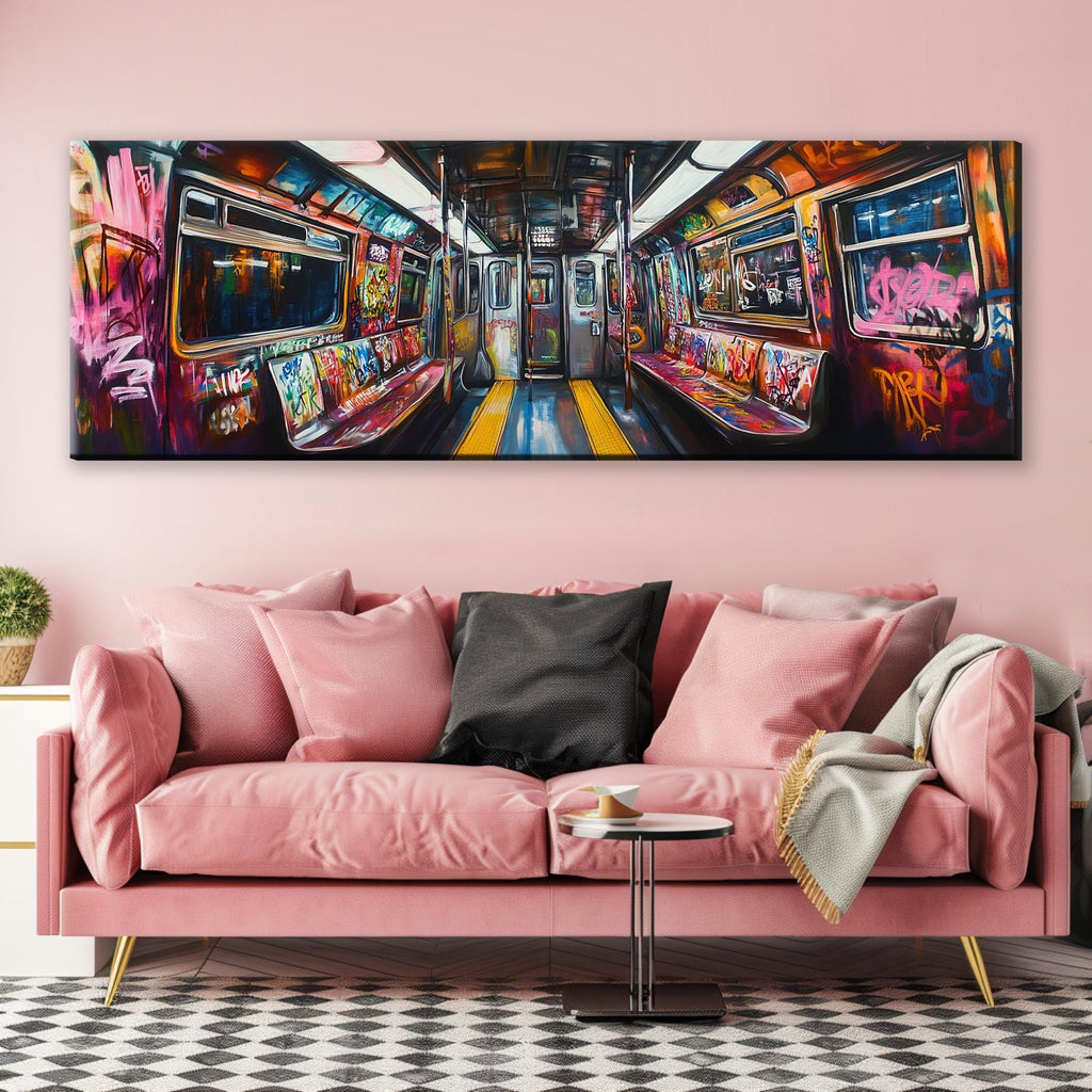a pink couch in a living room with a painting on the wall