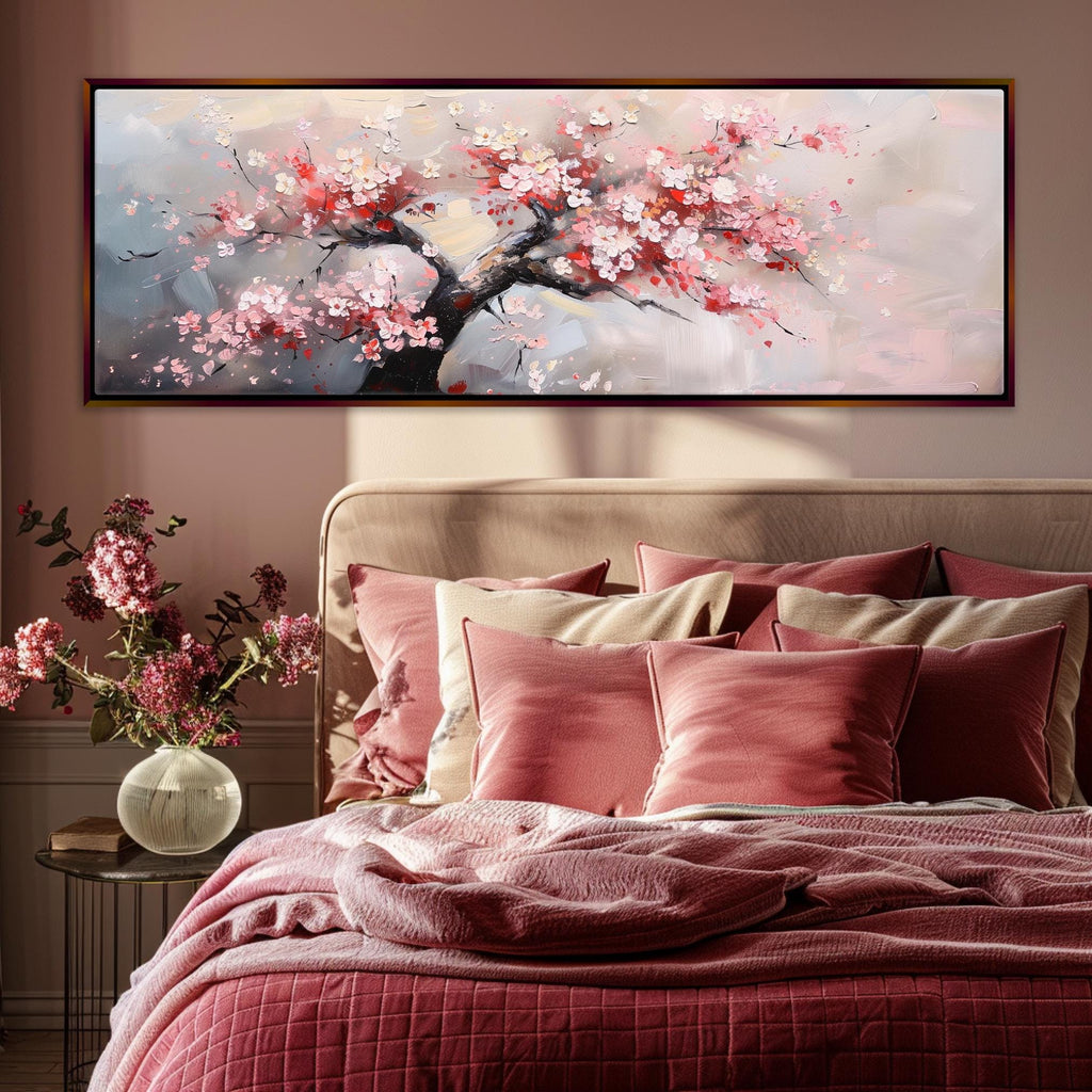 a bed with a pink comforter and a painting on the wall