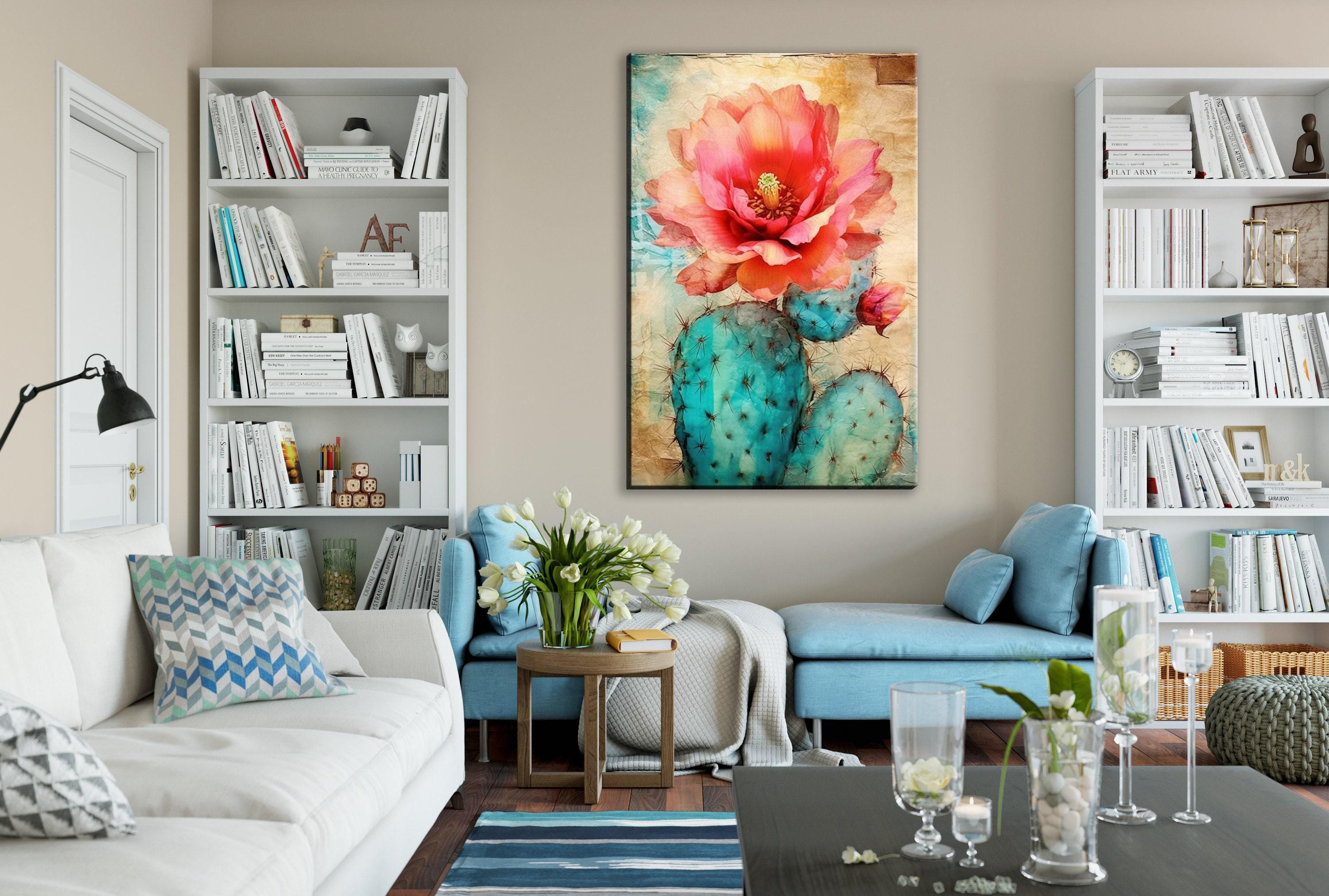 a cozy living room with a large bookshelf filled with books, a comfortable couch, a coffee table with decorative items, and a large painting of a cactus with a pink flower hanging on the wall.