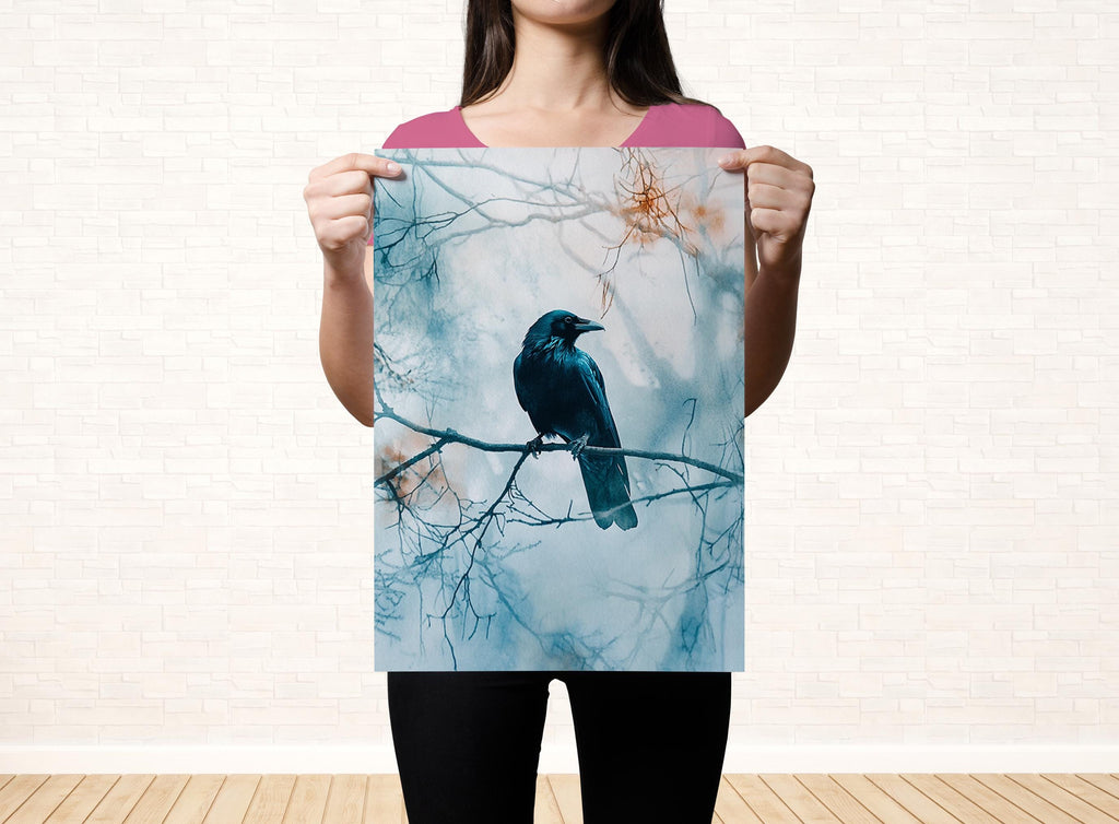 A woman holds up a framed print of a black bird perched on a branch, with a snowy background.