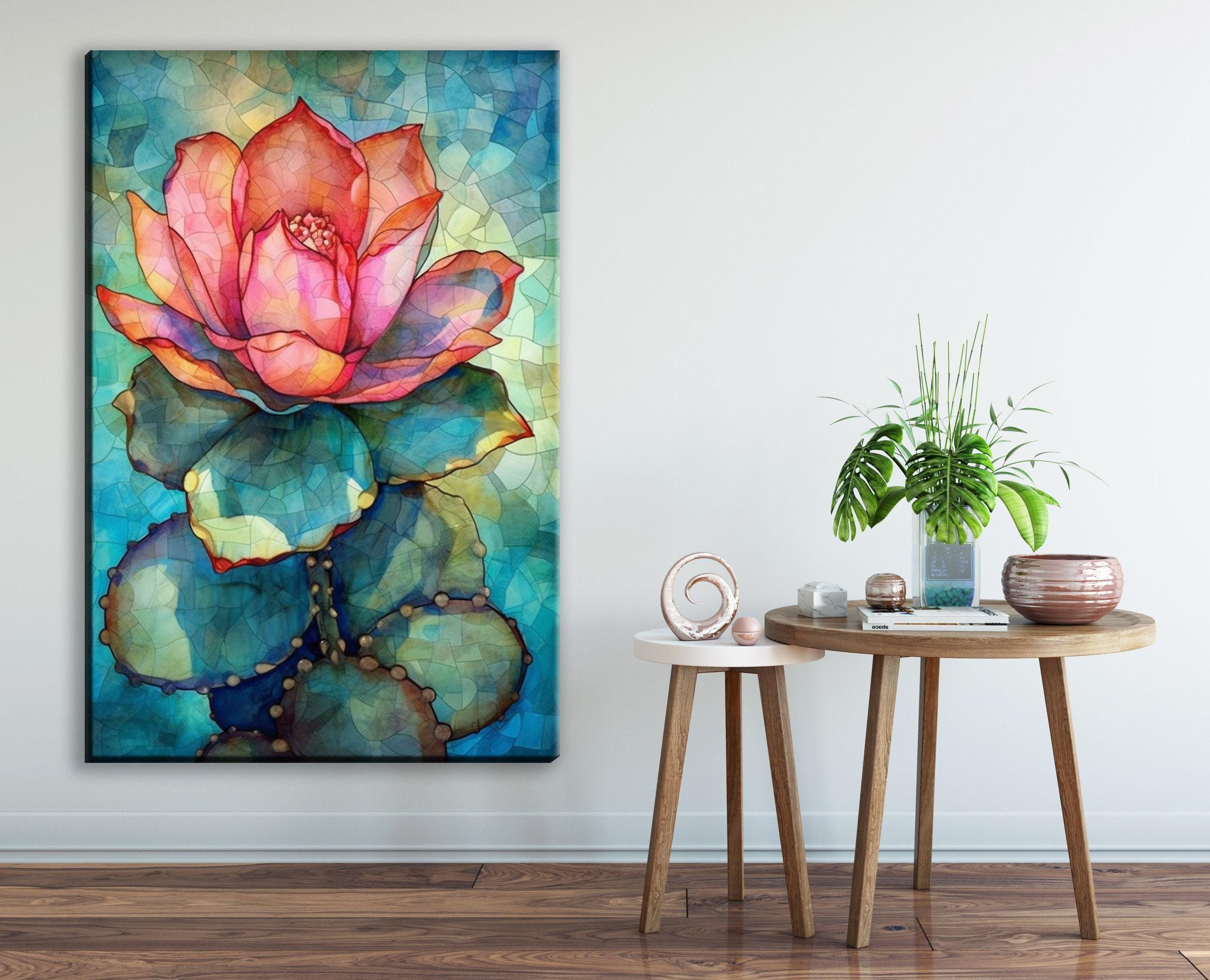 a large, colorful painting of a cactus flower on the wall, with a small round table and a potted plant in the foreground.