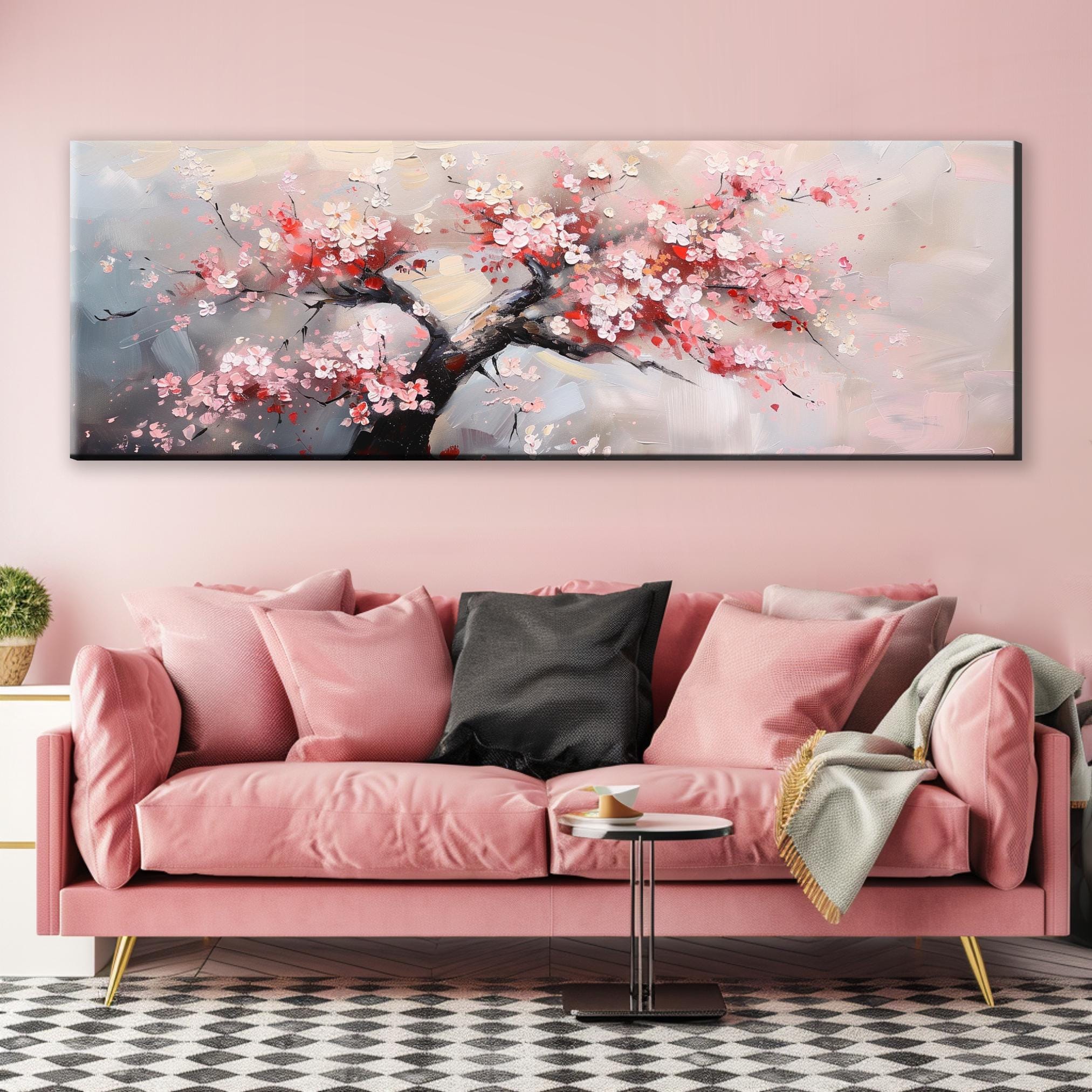 a living room with a pink couch and a painting on the wall