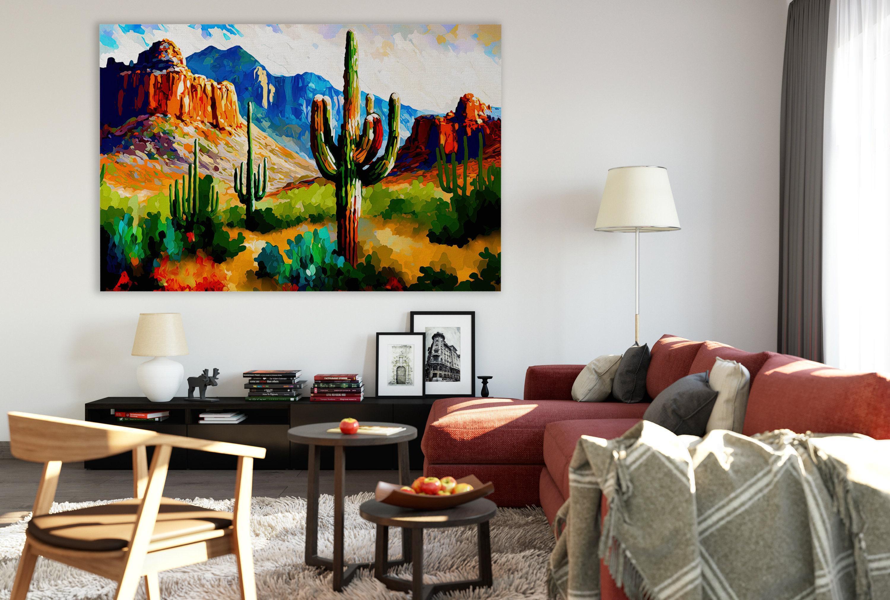 a cozy living room with a large painting of a desert landscape hanging on the wall. The painting features mountains, cacti, and a vibrant color palette, creating a warm and inviting atmosphere. The room is furnished with a red sofa, a wooden chair, and a coffee table with a bowl of fruit. The overall scene conveys a sense of comfort and relaxation, with the desert landscape painting serving as a focal point in the space.
