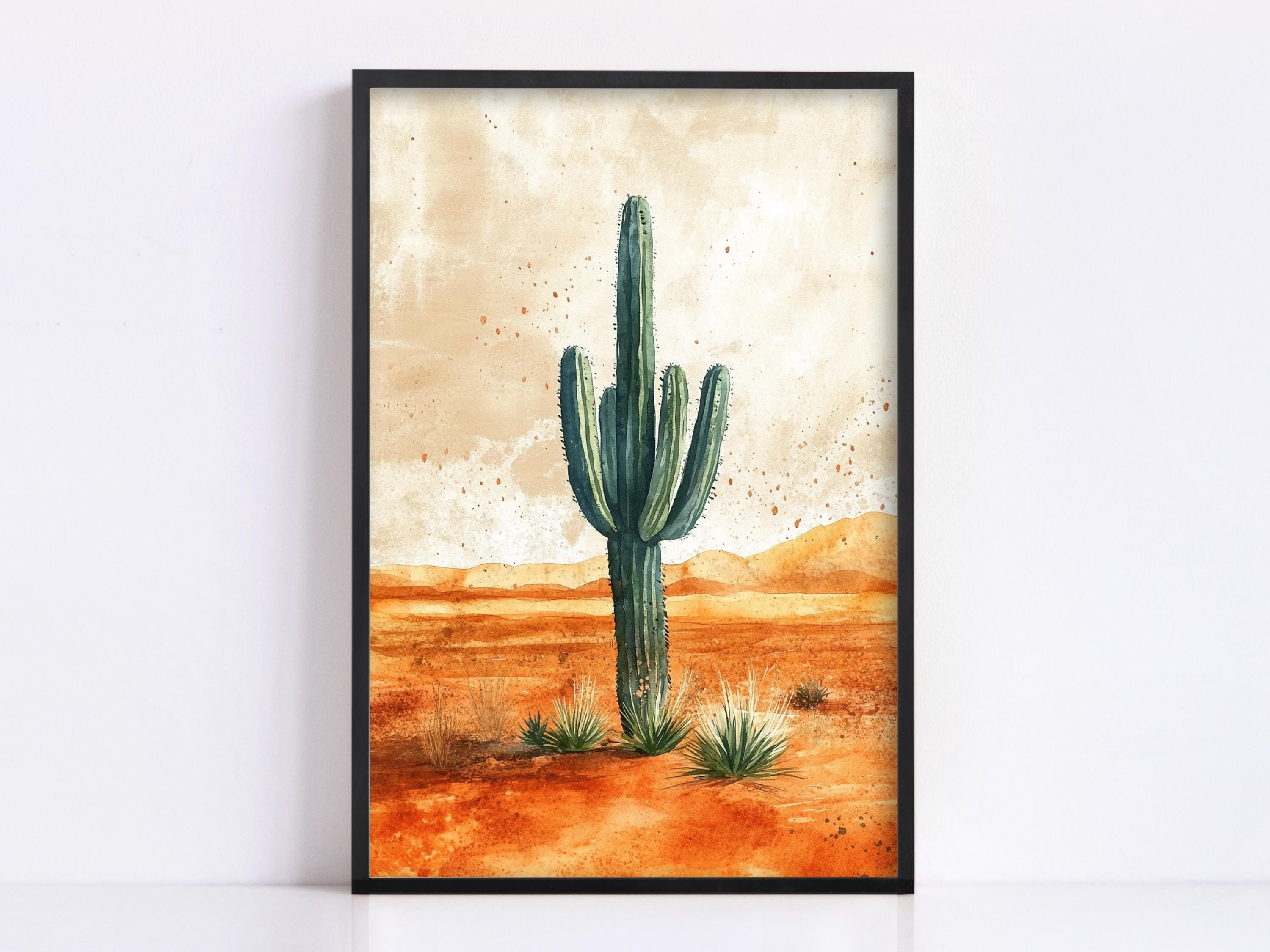 A framed painting depicting a tall cactus standing in a desert landscape with orange and brown terrain and scattered sparse vegetation.