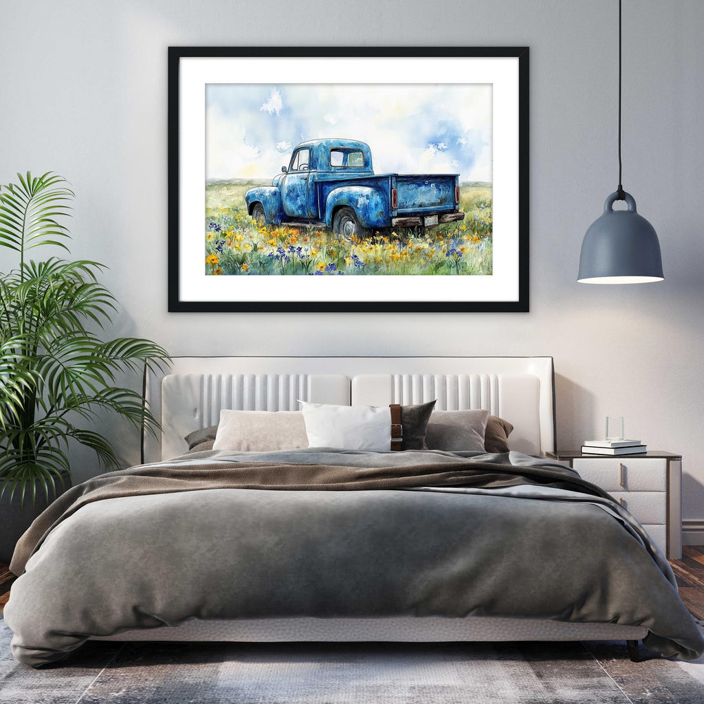 a bedroom with a large bed, a framed painting of a blue truck in a field, and a potted plant on the left side of the room.
