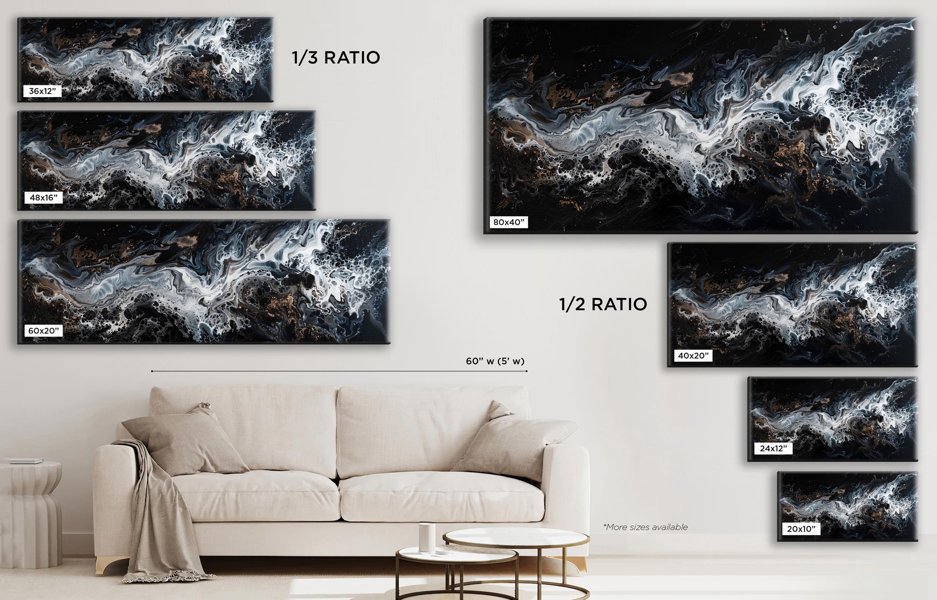 a living room with a white couch and several black and white paintings on the wall