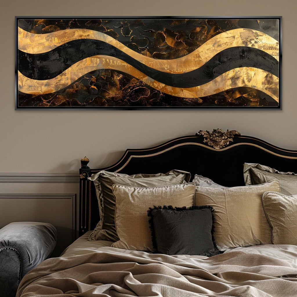a bed with a black headboard and a gold and black painting on the wall