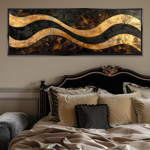 a bed with a black headboard and a gold and black painting on the wall