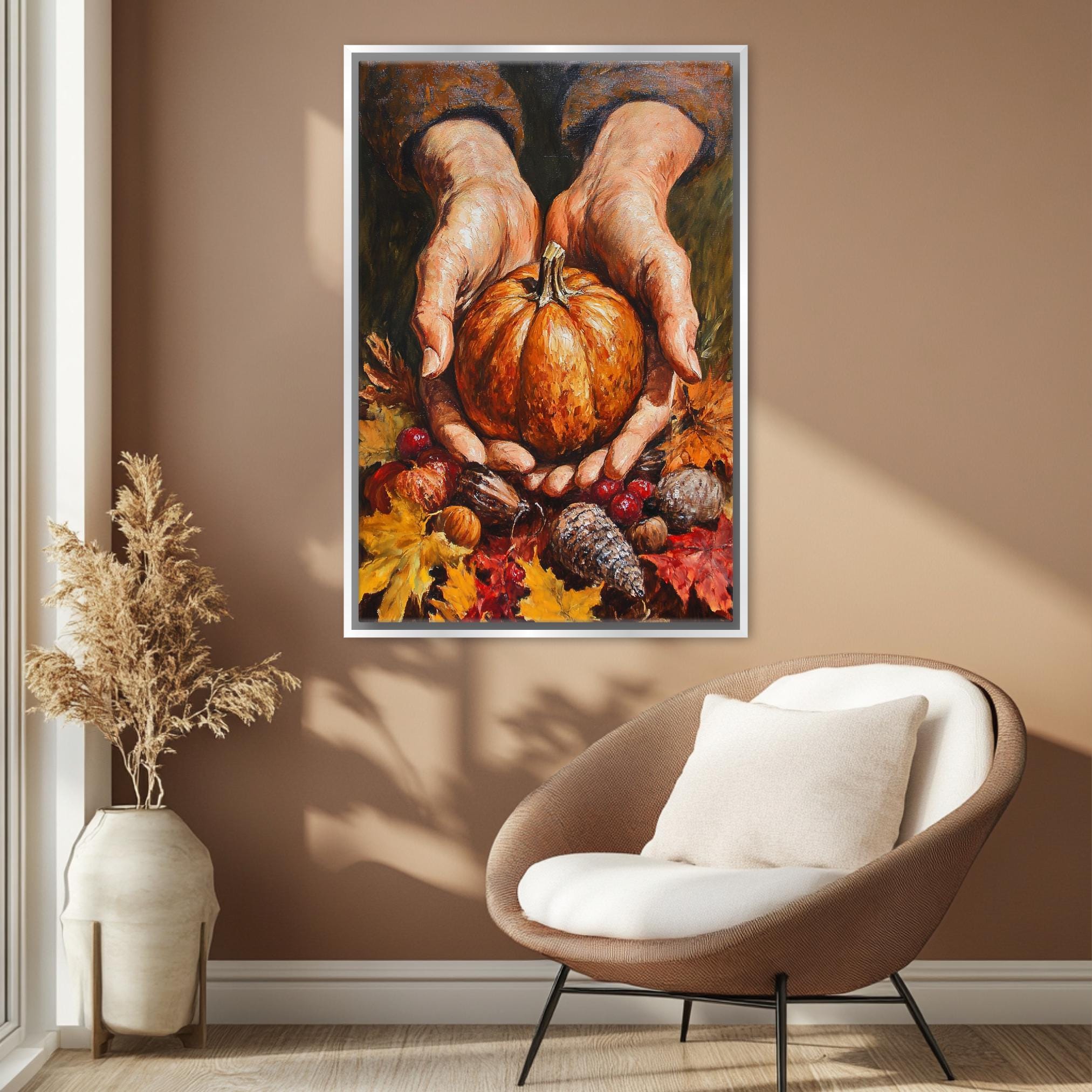 a cozy living room with a large painting of a pair of hands holding a pumpkin and autumn leaves hanging on the wall. The room is decorated with a brown armchair and a potted plant, creating a warm and inviting atmosphere.