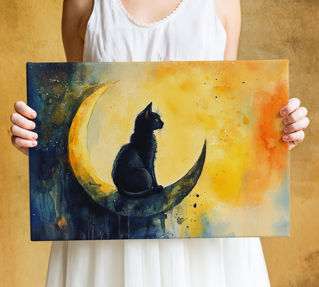 A woman holds a painting of a black cat sitting on a crescent moon against a vibrant yellow and orange background.