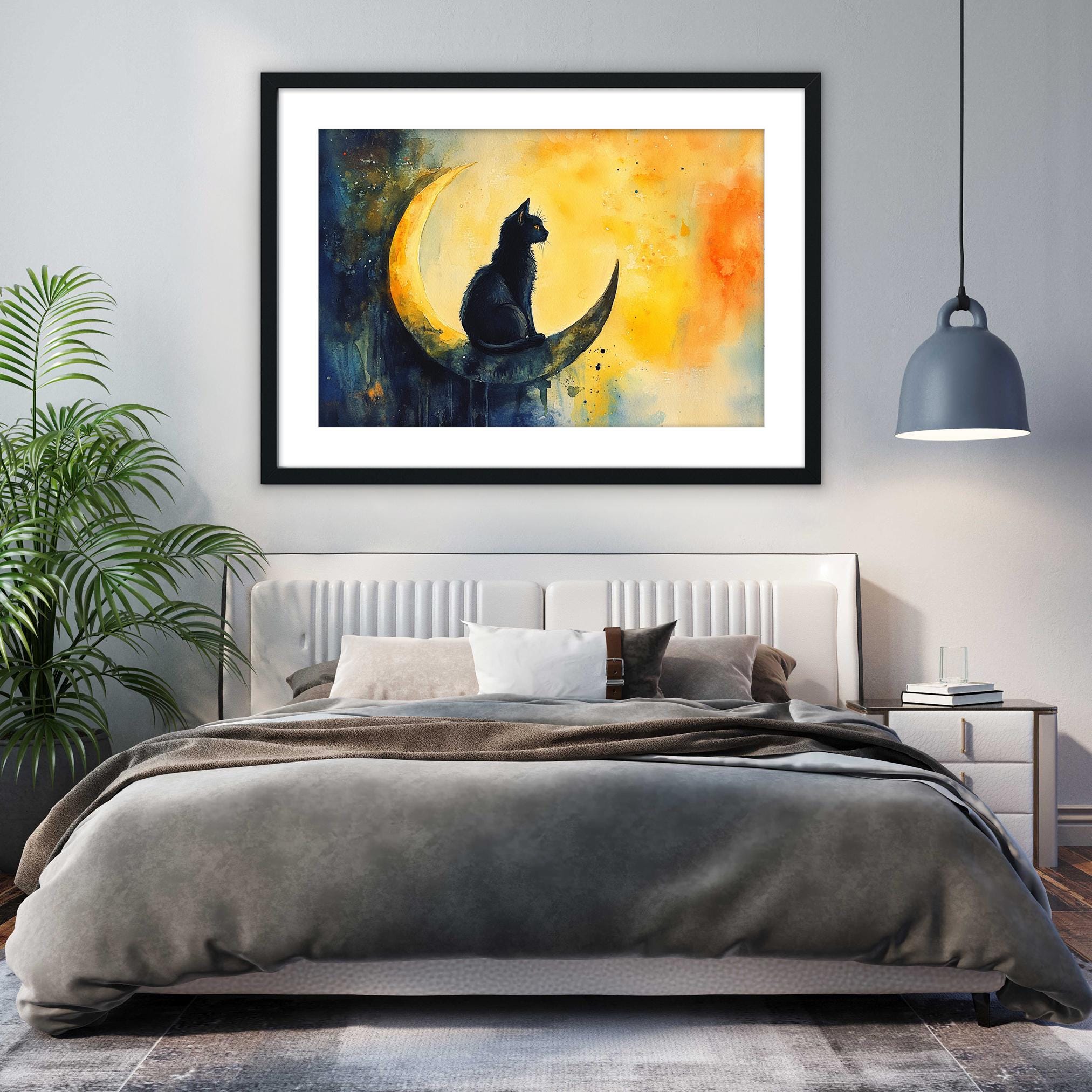 a bedroom with a large bed, a framed painting of a cat sitting on a crescent moon, and a potted plant on the left side of the room.