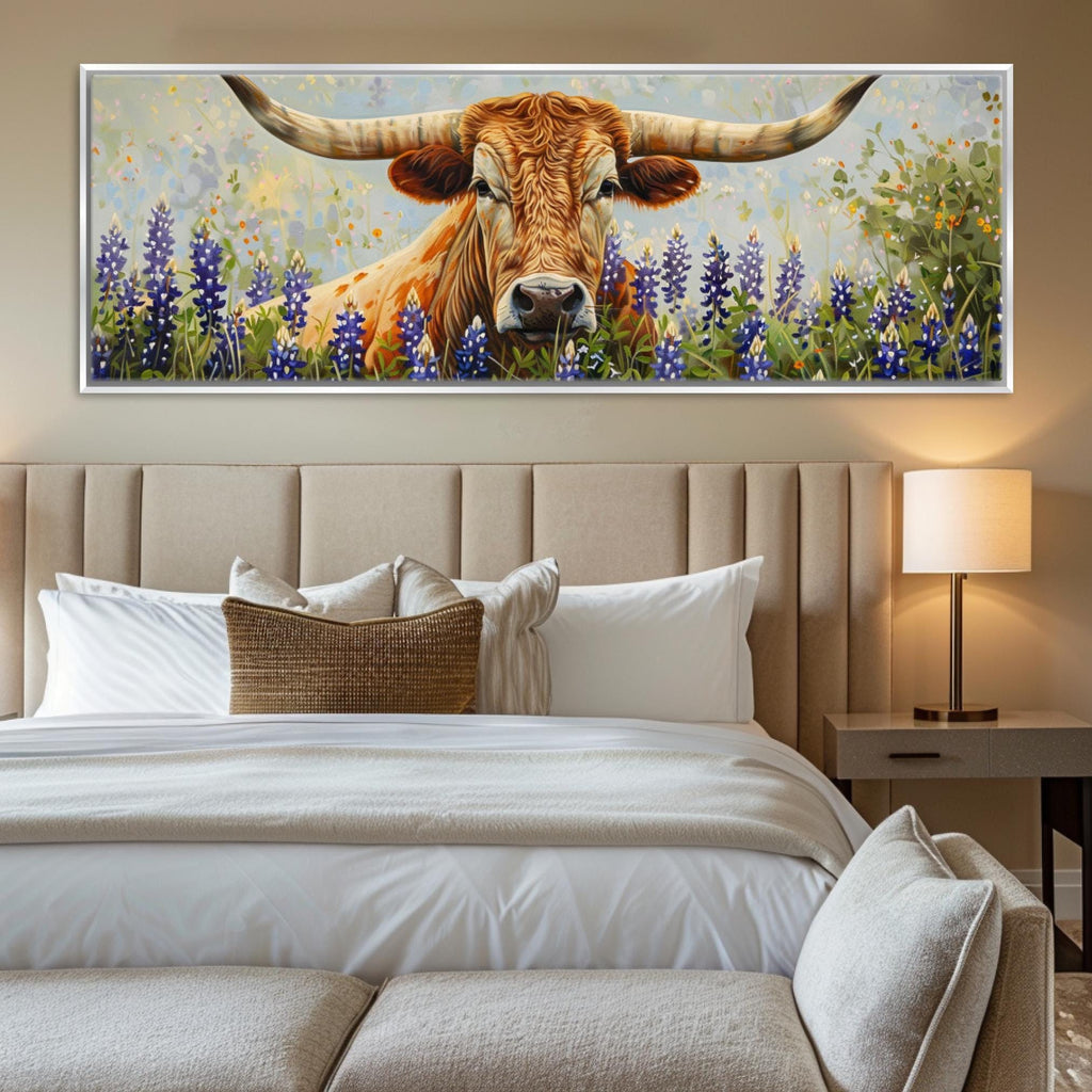 a large painting of a bull with horns, set against a backdrop of a field with purple flowers. The painting is displayed on the wall above a bed with white linens and a headboard.