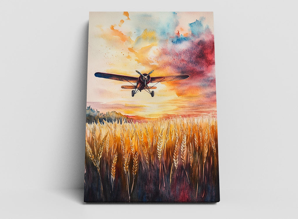 A watercolor painting depicting a small airplane flying over a field of golden wheat against a vibrant sunset sky.