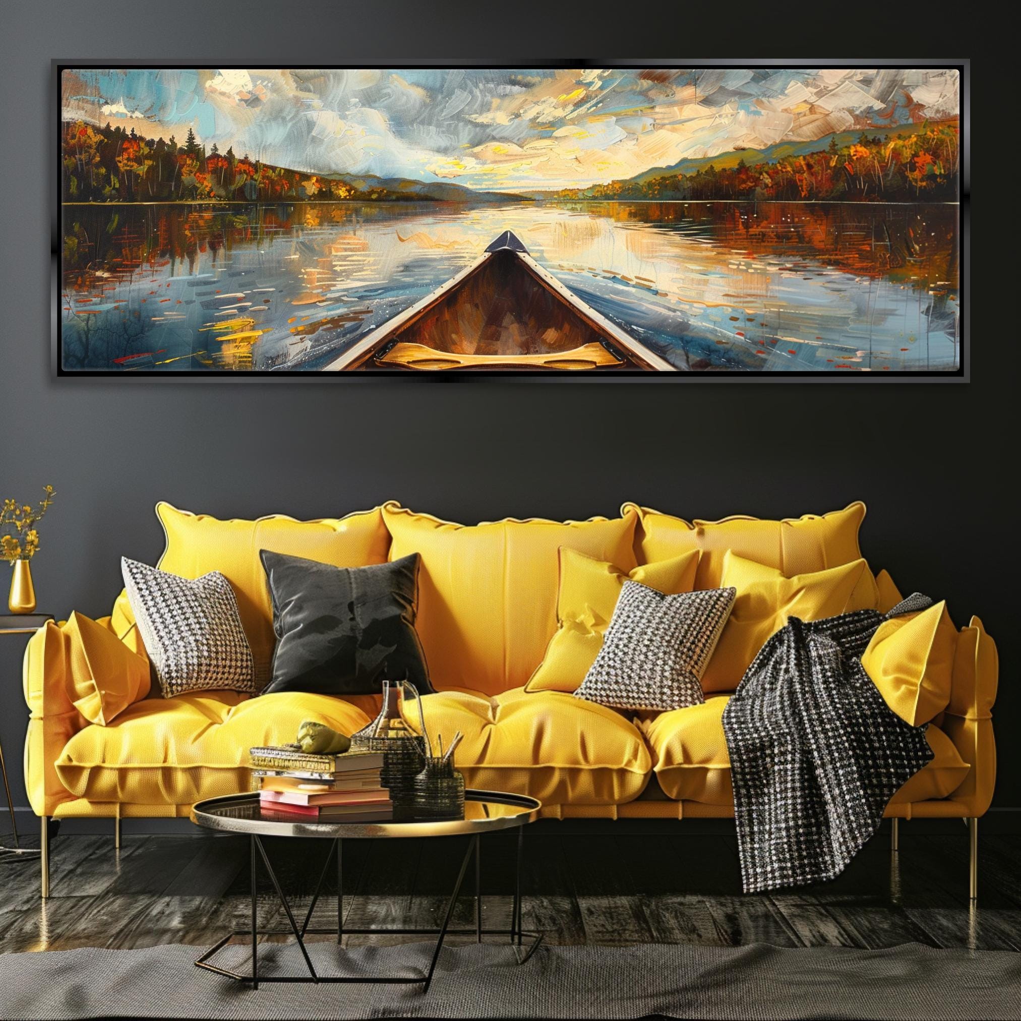 a large painting of a boat on a lake, with a colorful and vibrant landscape in the background. The painting is displayed on a wall above a yellow couch, which is adorned with throw pillows and a blanket. In front of the couch, there is a coffee table with a few decorative items on it.