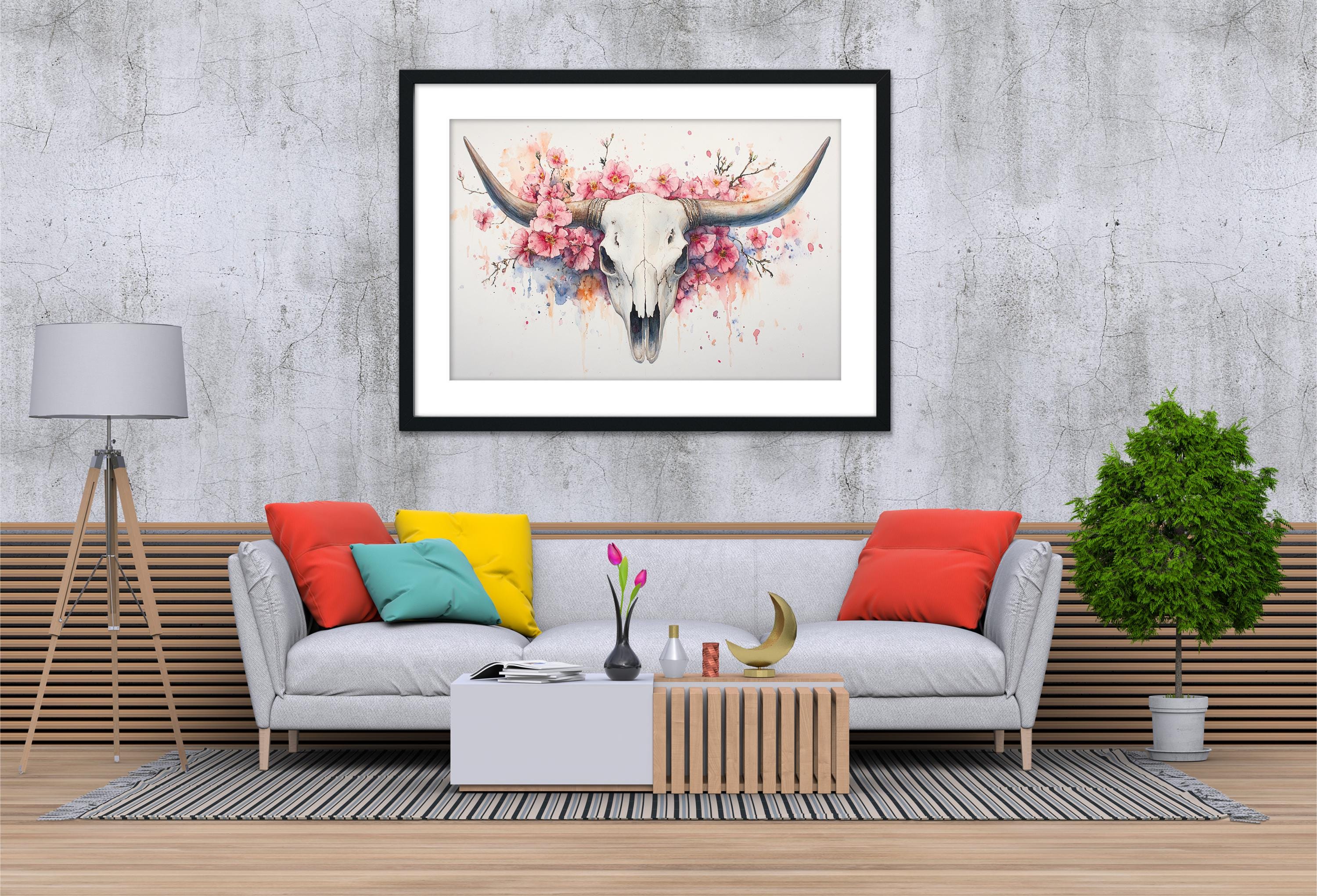 a modern living room with a gray sofa adorned with colorful throw pillows, a wooden coffee table, and a framed artwork of a bull's skull with pink flowers hanging above it.