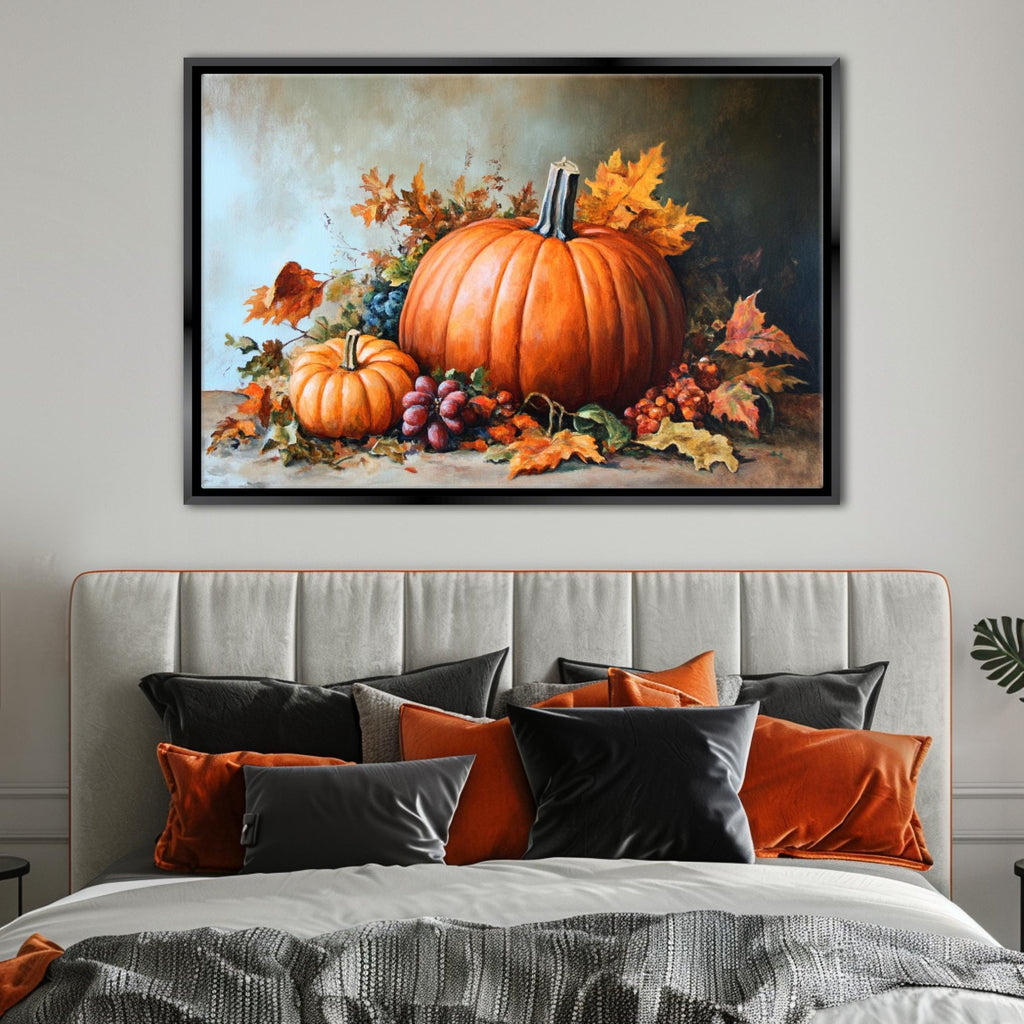 a large framed painting of a pumpkin and autumn leaves hanging above a bed with a gray headboard and colorful pillows.