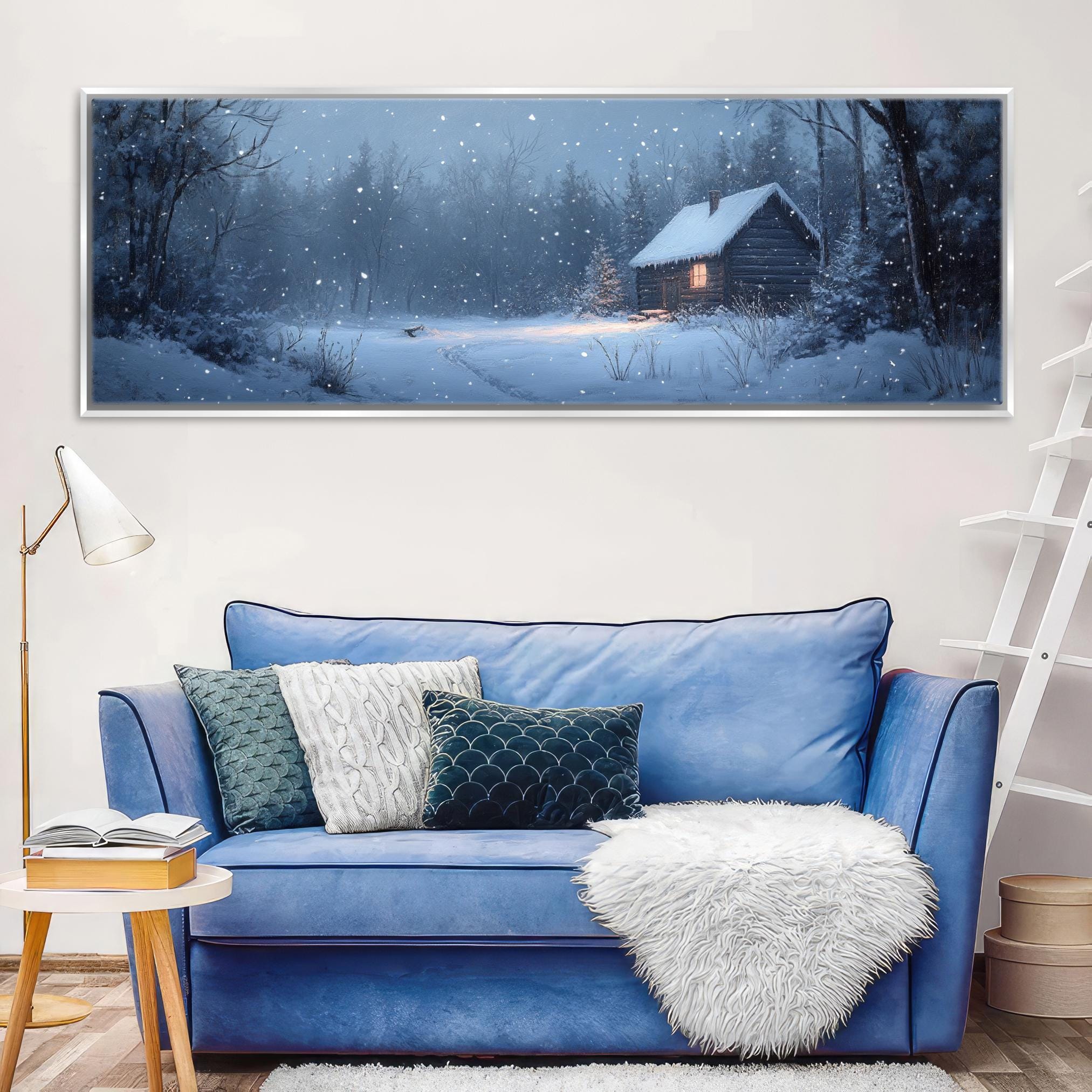 a living room with a blue couch and a painting on the wall