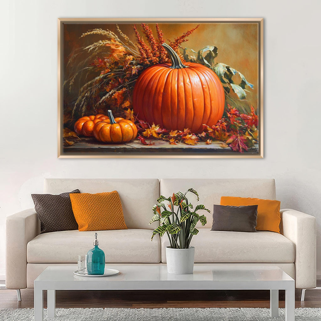 a cozy living room with a white sofa adorned with orange and brown throw pillows. Above the sofa, a large painting of pumpkins and autumn foliage hangs on the wall, creating a warm and inviting atmosphere. In front of the sofa, there is a coffee table with a blue vase and a plant, adding a touch of nature and color to the space.