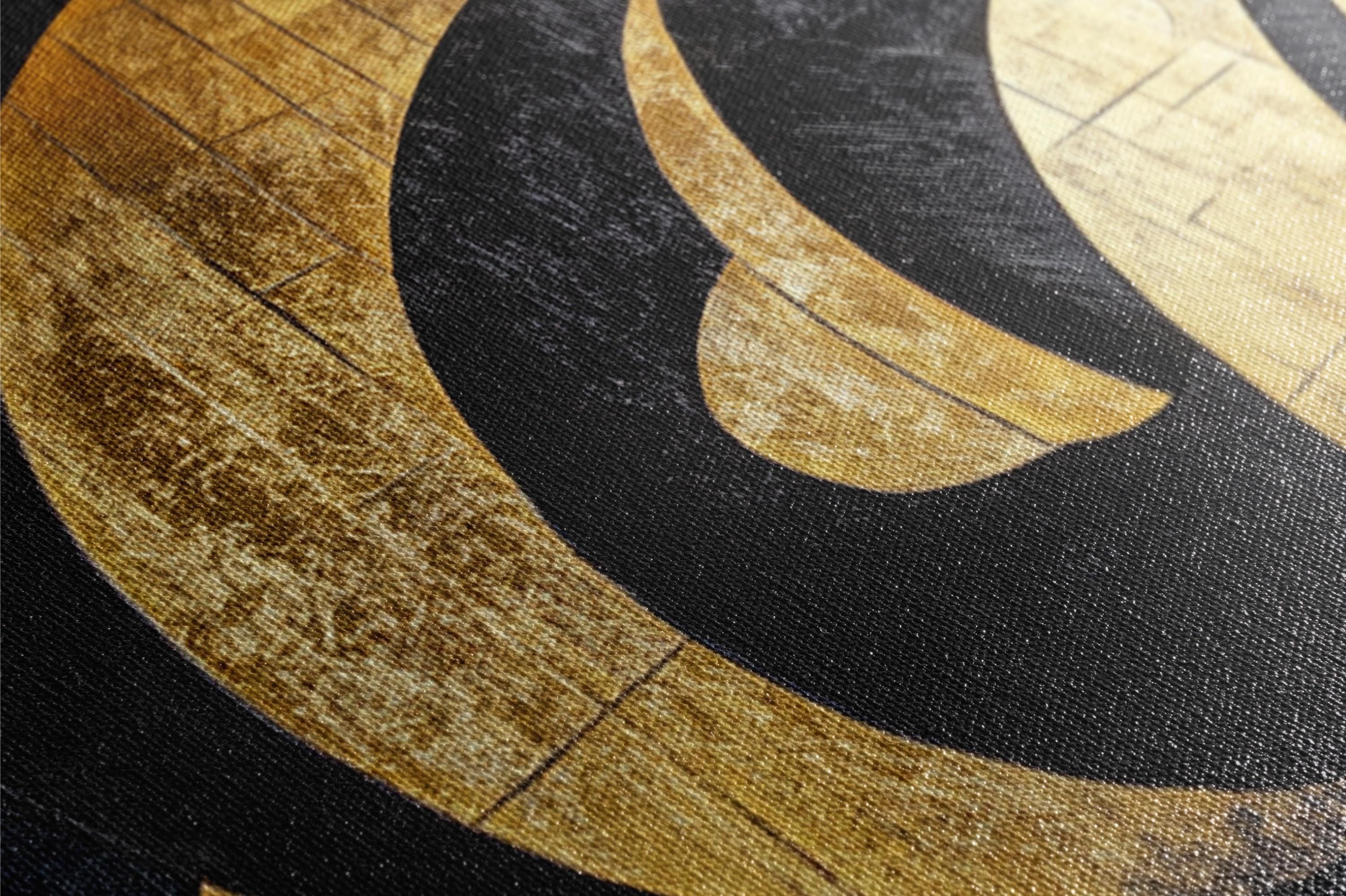 a close up of a black and gold pattern on a piece of paper
