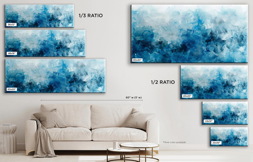 a living room with a white couch and blue paintings on the wall