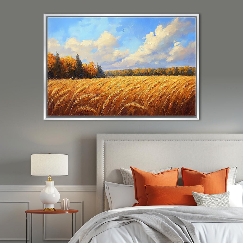 a serene bedroom scene with a large painting of a golden wheat field hanging on the wall above a bed with orange pillows.