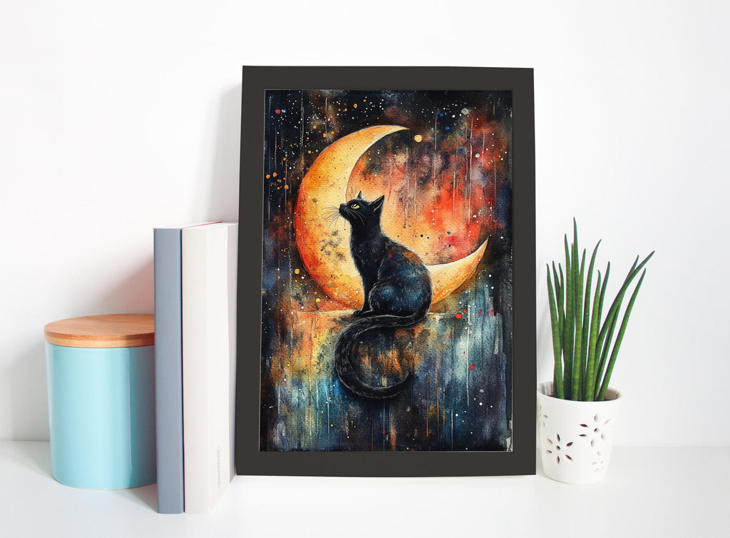 a framed painting of a black cat sitting on a crescent moon, surrounded by a starry night sky. The painting is displayed on a white shelf, with a blue container, a white book, and a white vase with a green plant nearby.