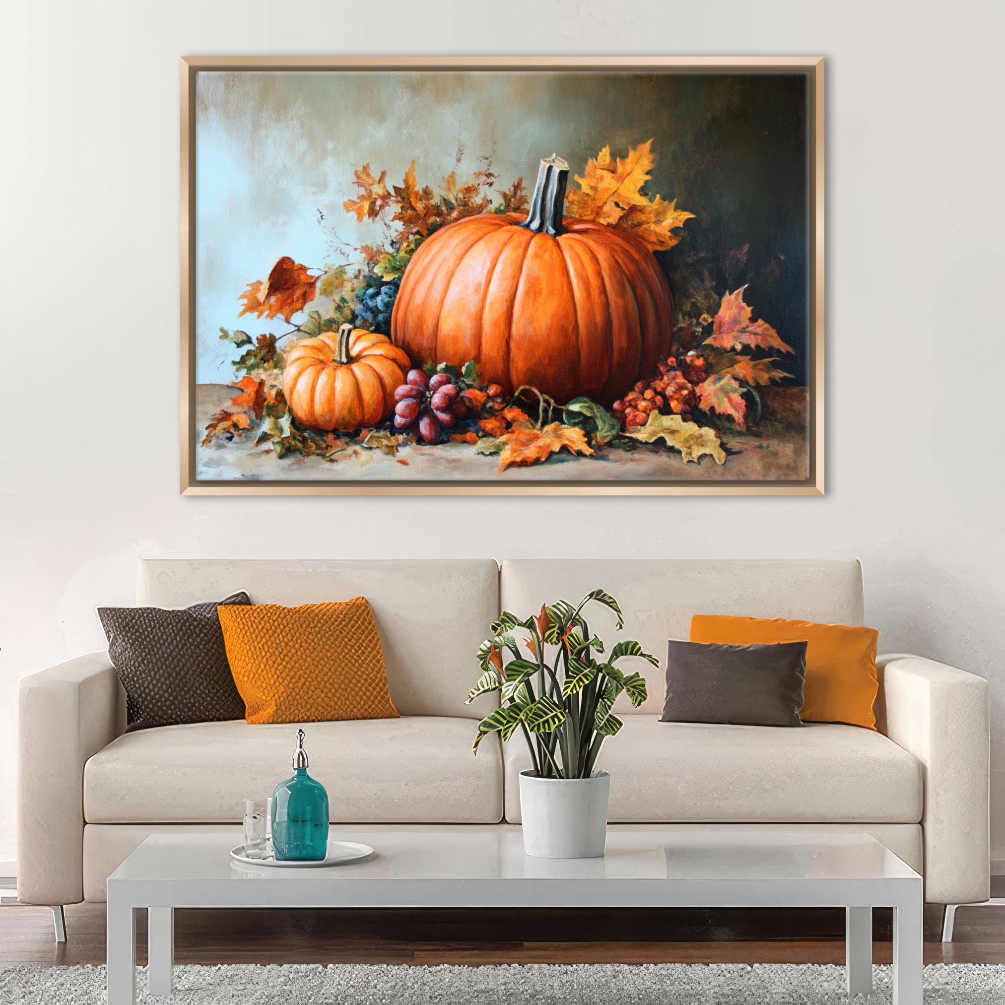a large painting of a pumpkin and other fall-themed elements hanging on a wall above a white sofa with colorful throw pillows.