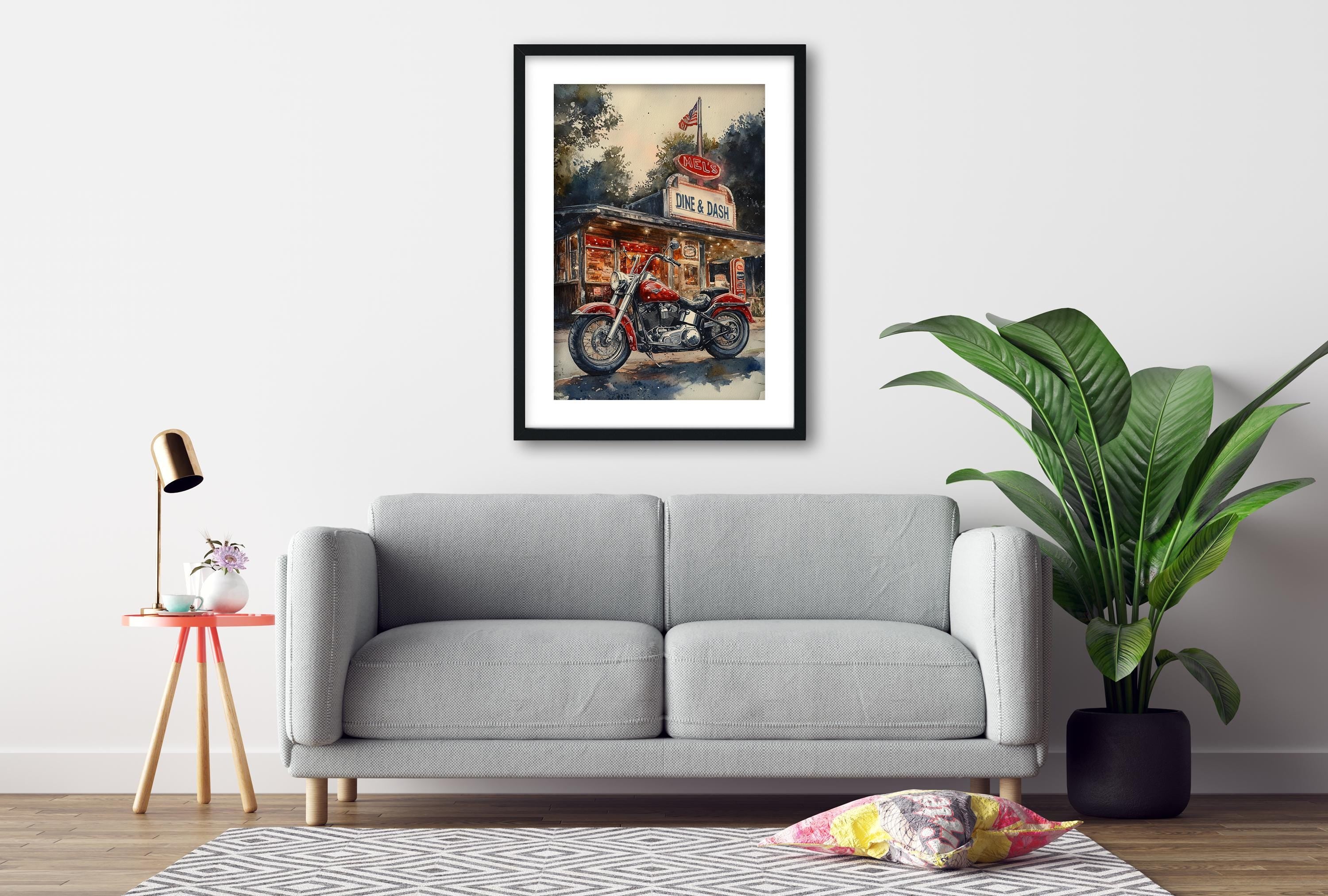 a gray sofa, a framed painting of a motorcycle, a red table lamp, a potted plant, and a patterned rug on a wooden floor.
