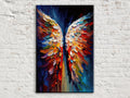 A vibrant, colorful painting of a pair of wings against a dark background, hanging on a white brick wall.