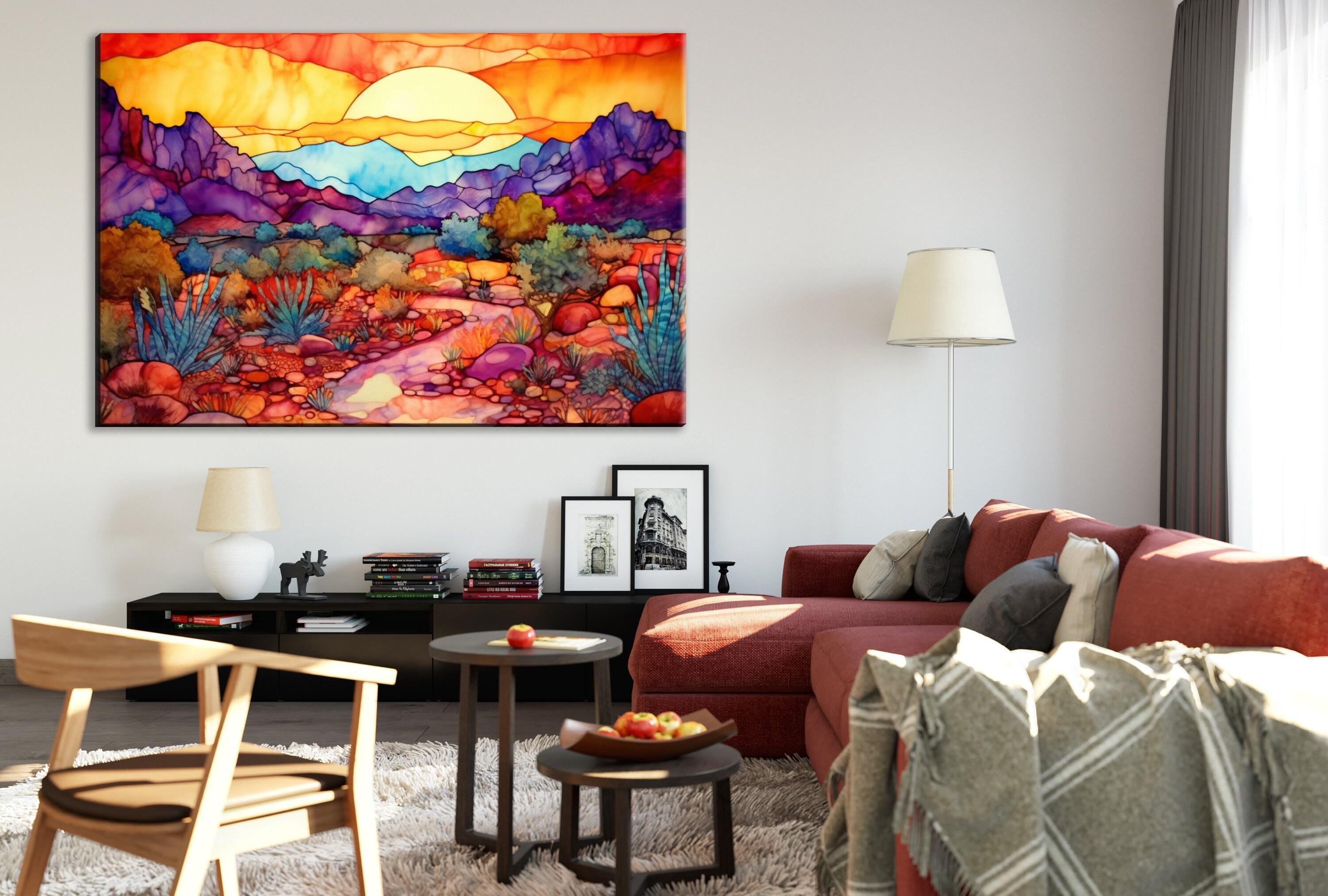 a cozy living room with a large, colorful painting of a desert landscape hanging on the wall. The room is furnished with a red sofa, a wooden chair, and a coffee table with a bowl of fruit. The overall atmosphere of the room is warm and inviting, with the painting adding a vibrant touch to the space.
