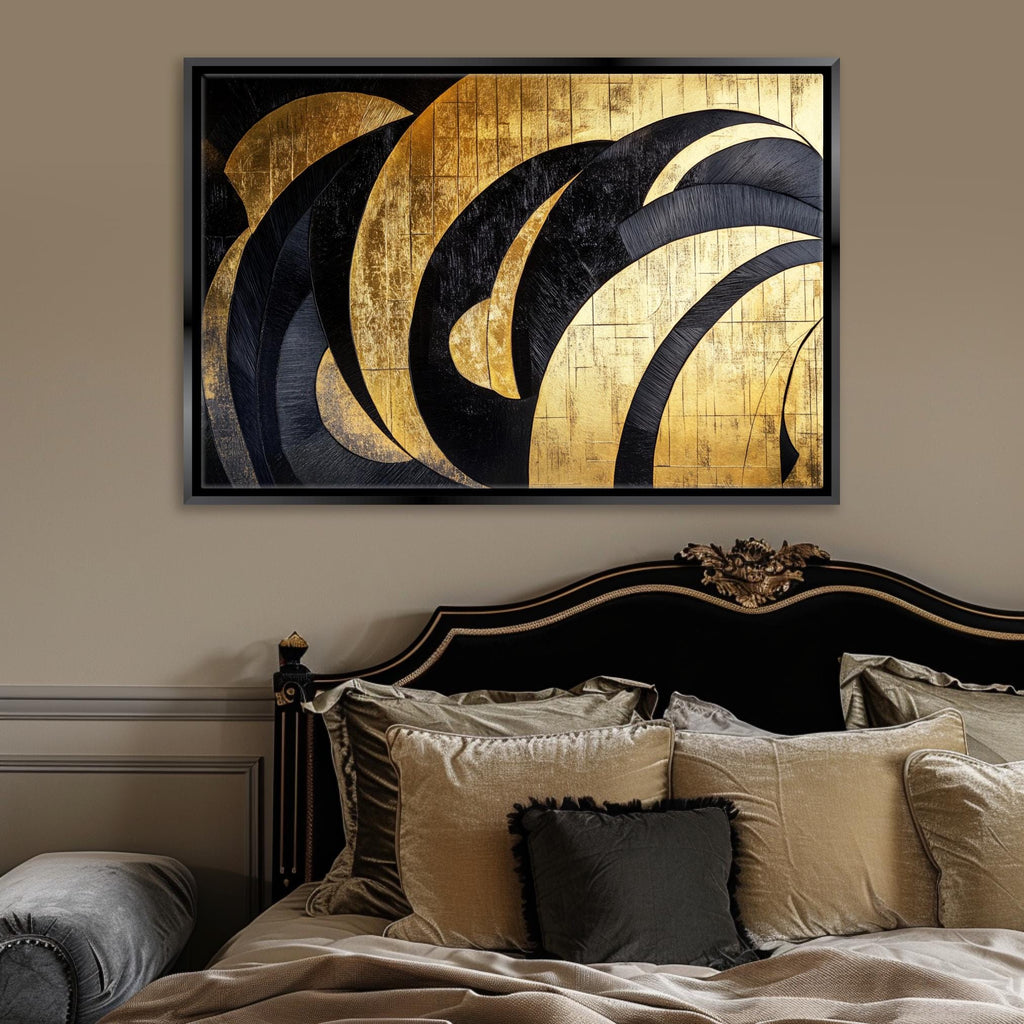a bed with a black headboard and a gold and black painting on the wall