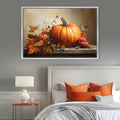 a large framed painting of a pumpkin and autumn leaves on a wall above a bed with orange pillows and a white headboard.