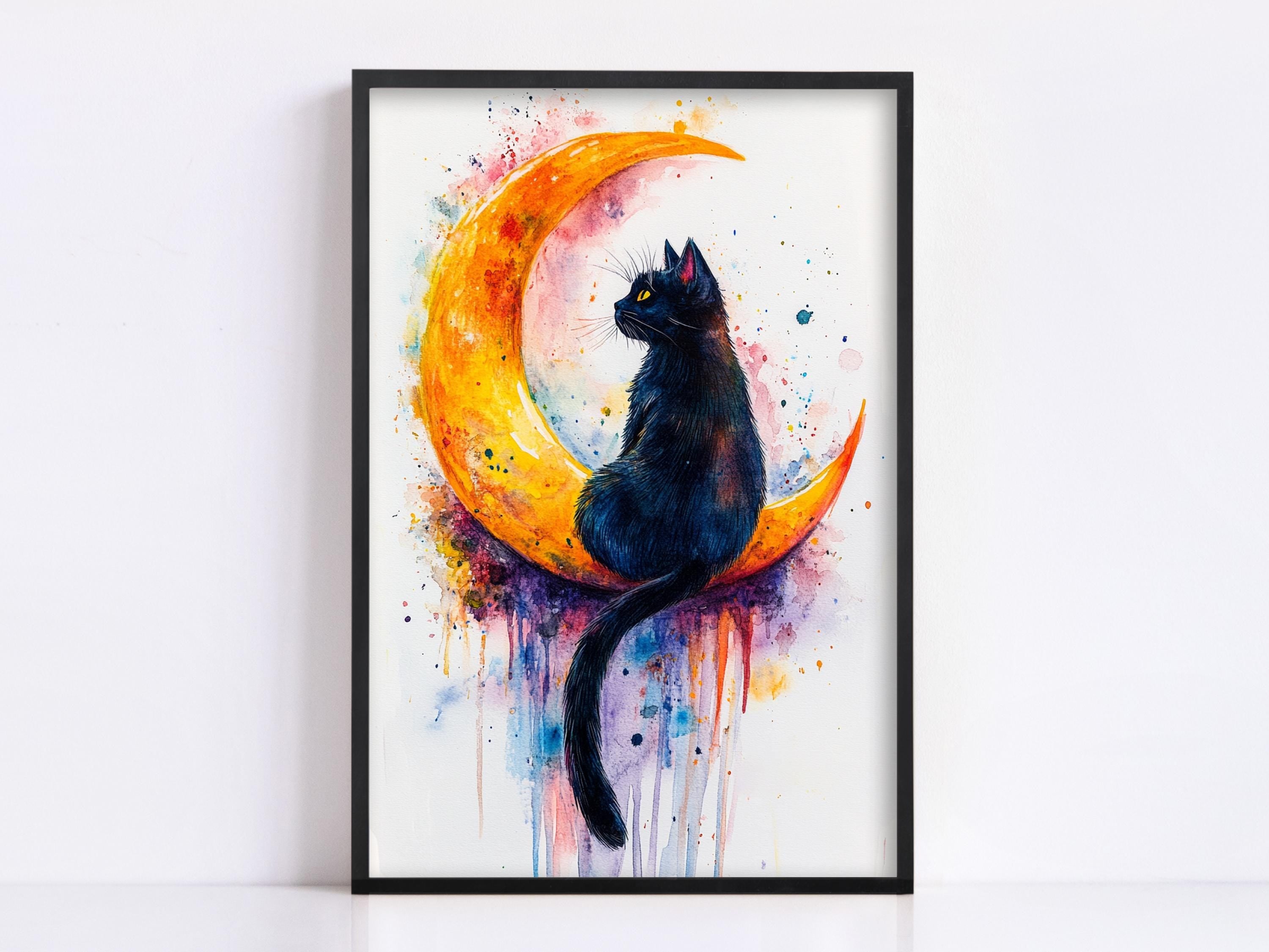 A framed painting depicting a black cat sitting on a crescent moon, with splashes of color surrounding the moon.