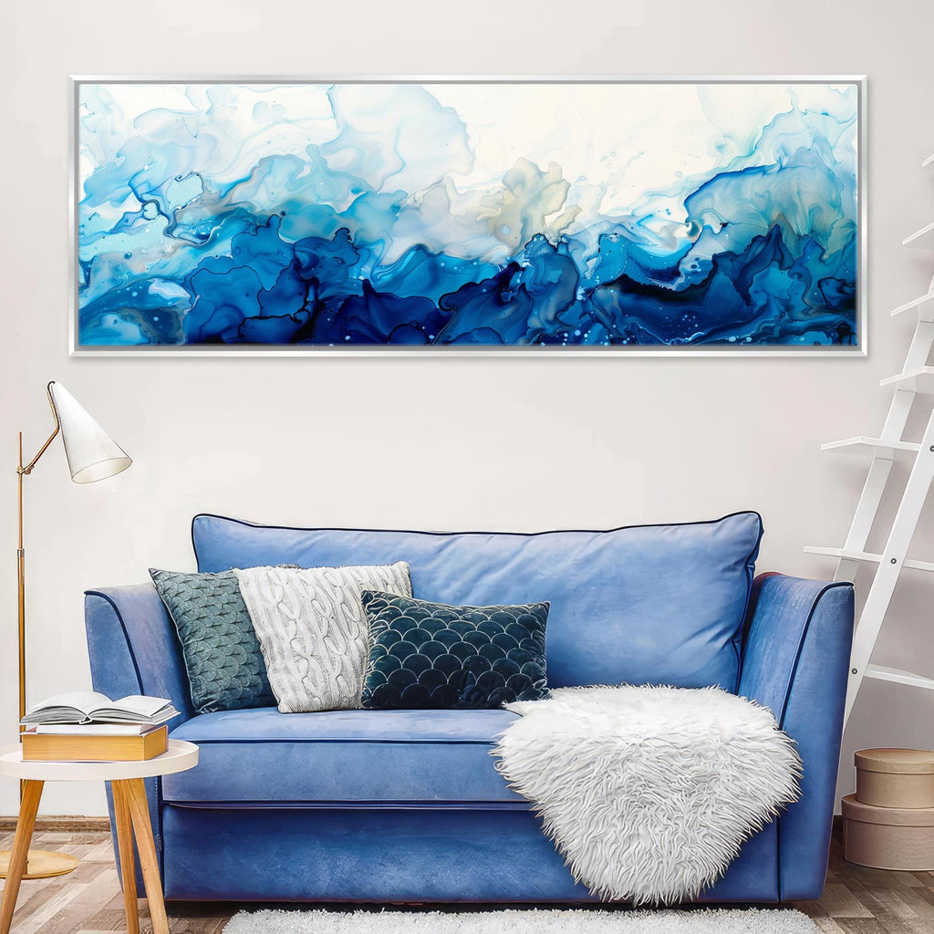 a living room with a blue couch and a painting on the wall