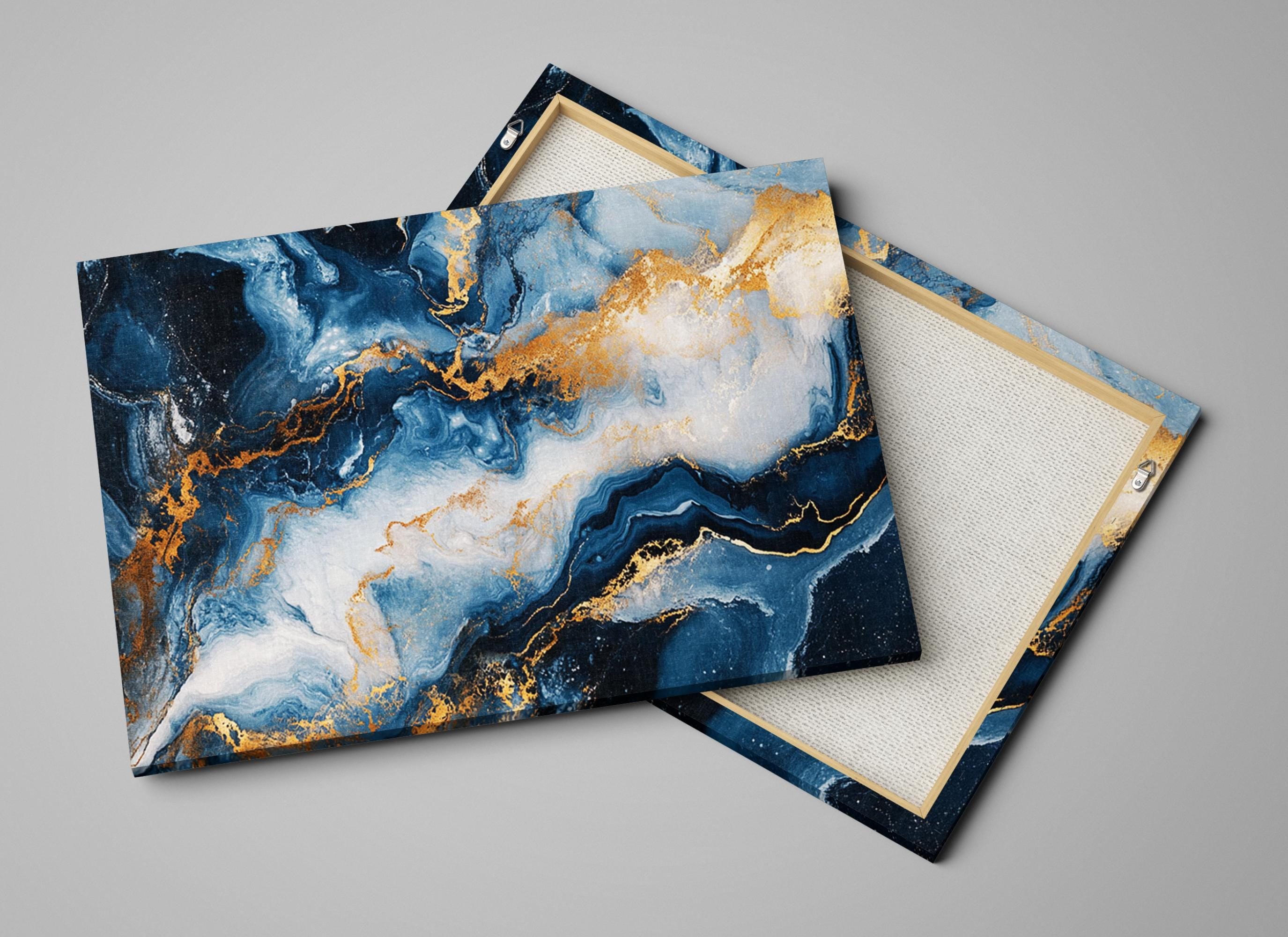 a pair of blue and gold marbled coasters