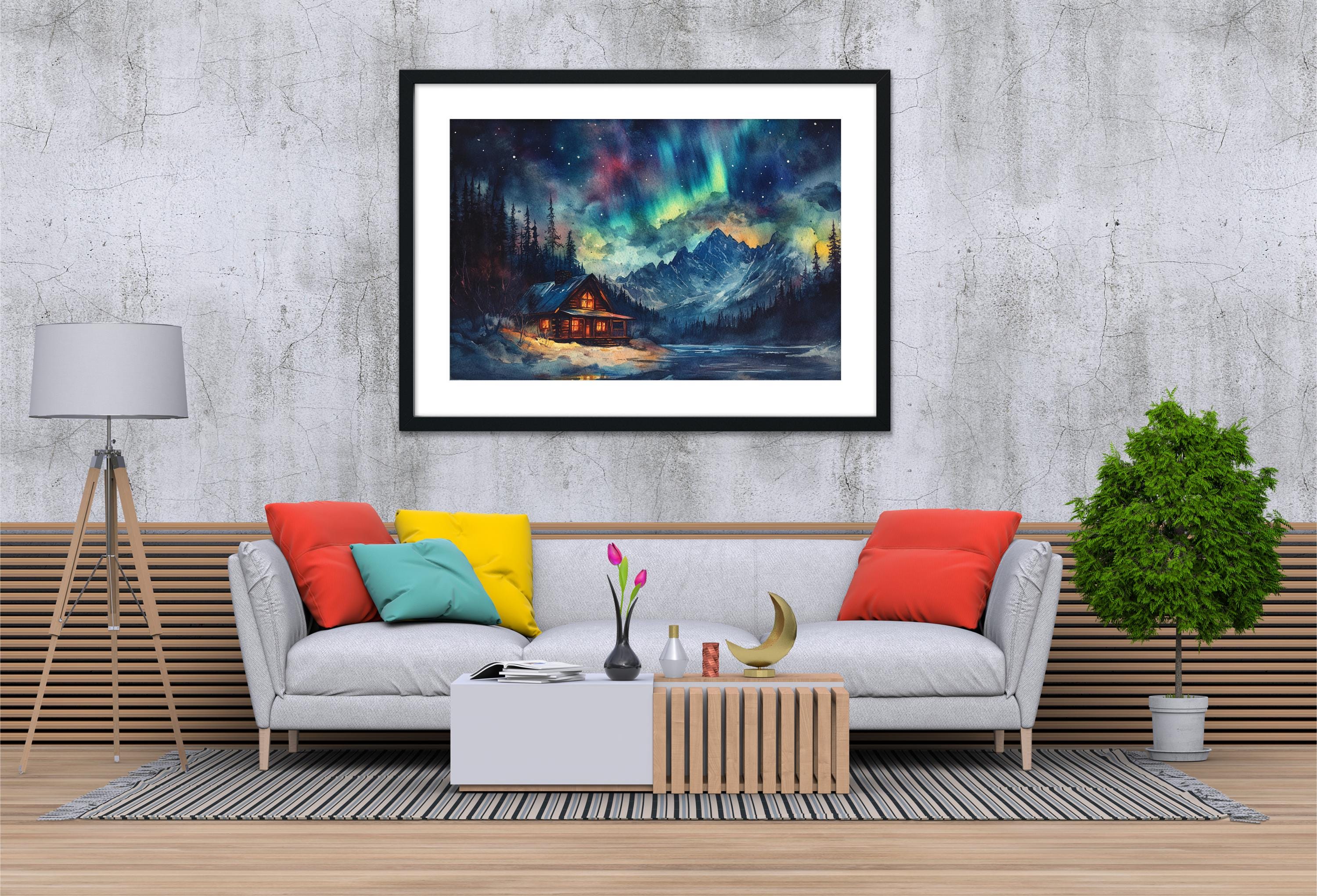 a cozy living room with a gray sofa adorned with colorful pillows, a wooden coffee table, and a framed painting of a cabin in the mountains hanging on the wall above the sofa.